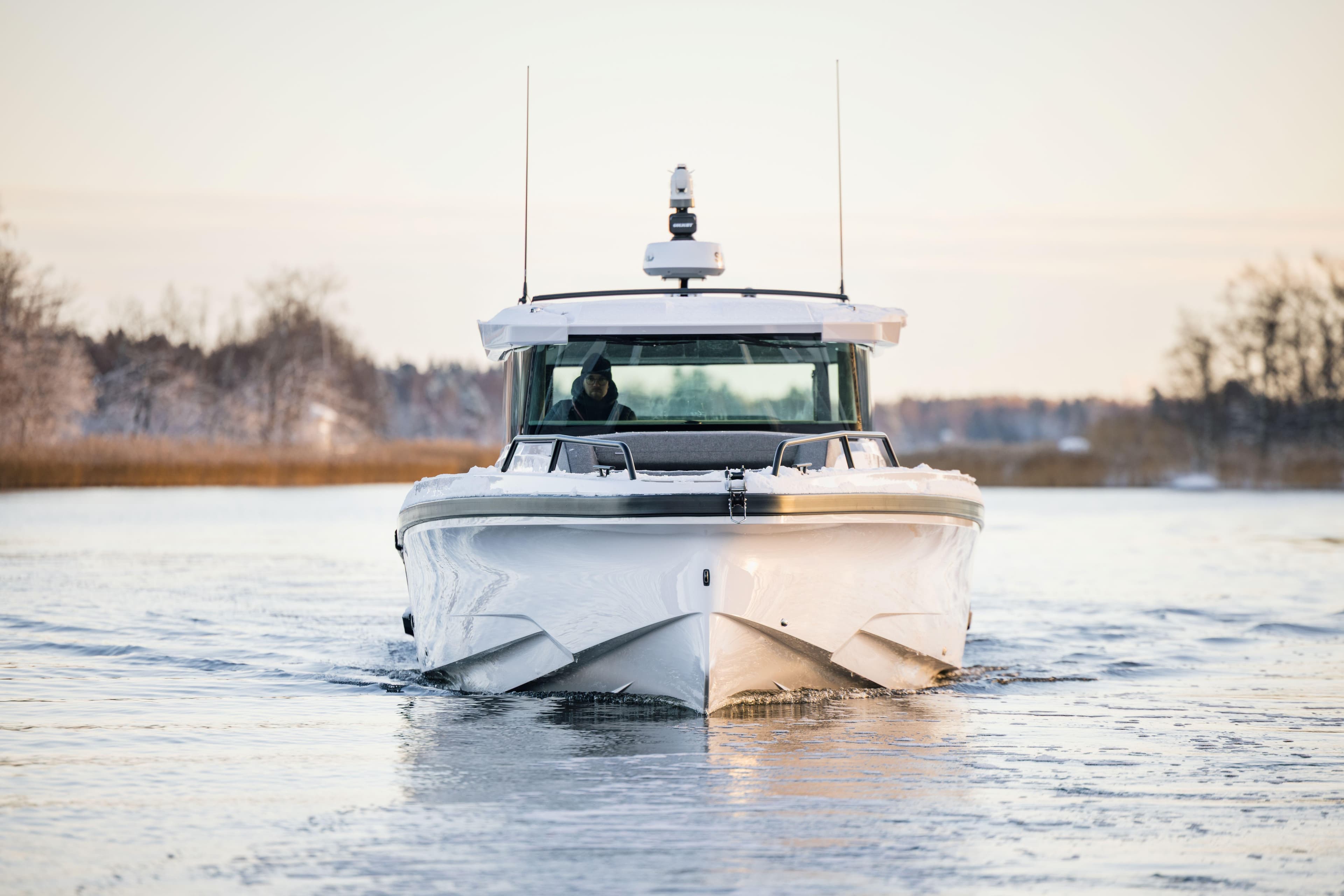 2026 Axopar 38 Cross Cabin boat navigating icy waters, front view.