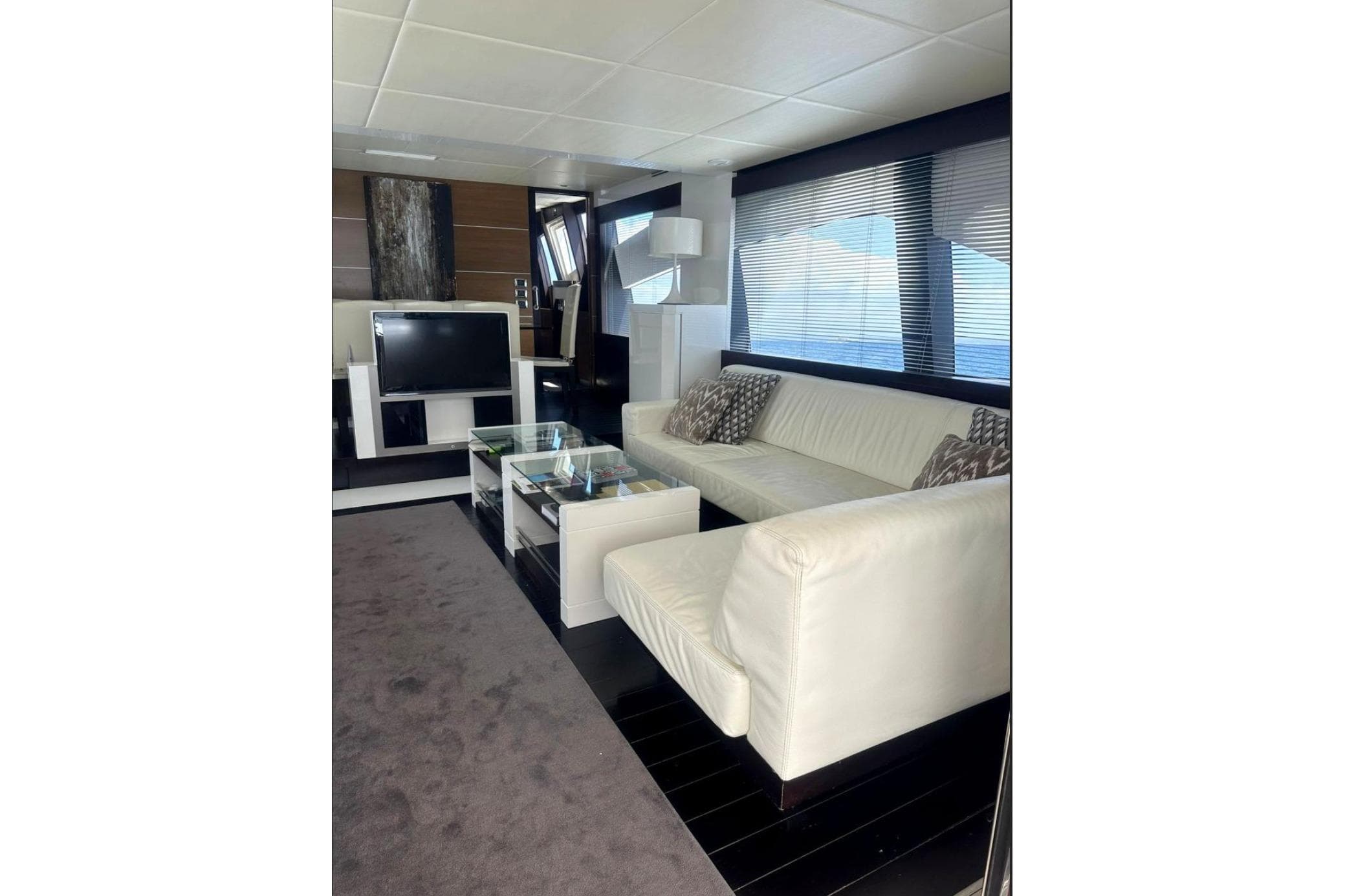 Luxurious interior of 2008 Astondoa 76 GLX yacht with white leather seating and modern decor.