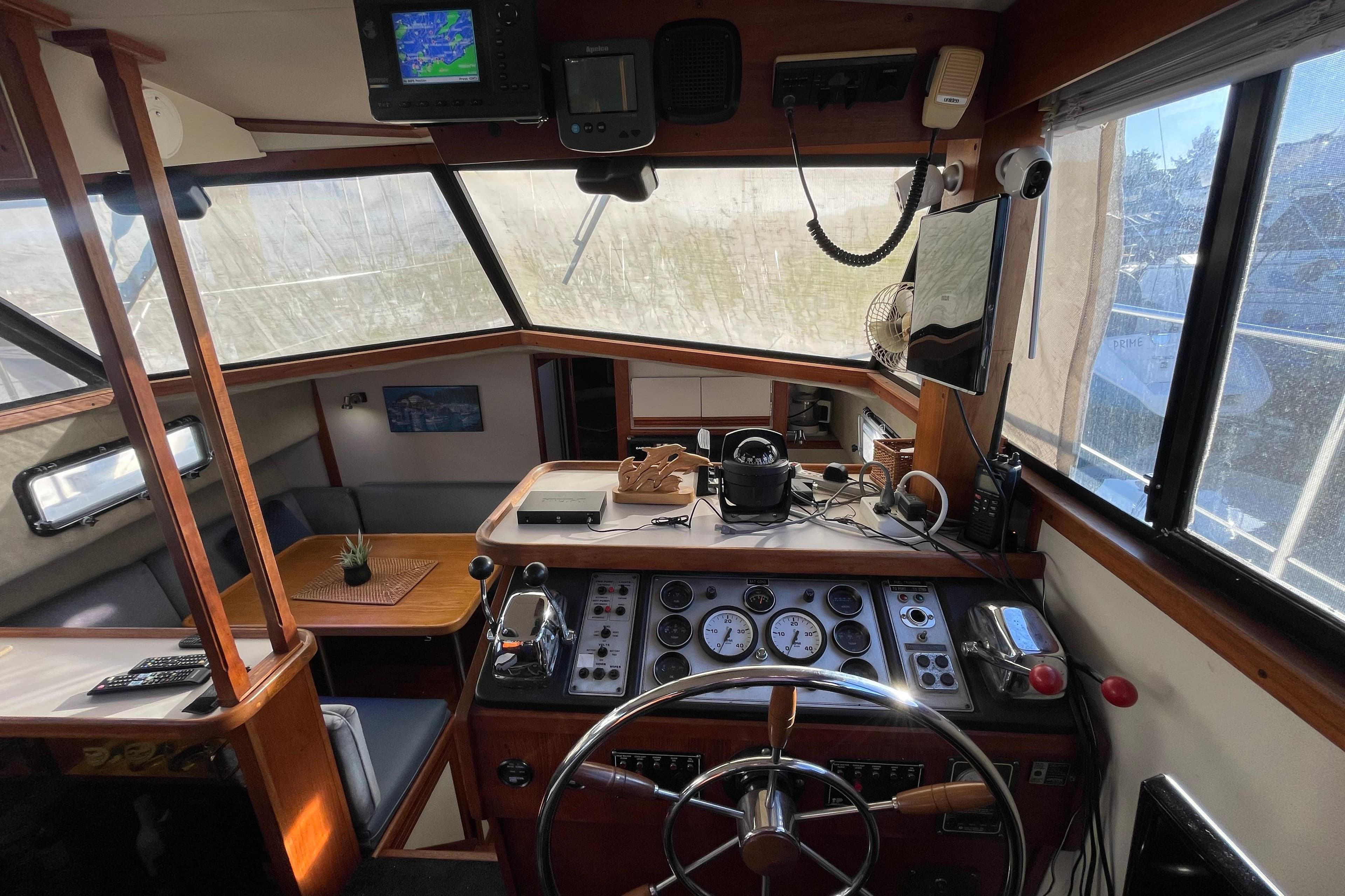 Interior of 1988 Carver 3607 Aft Cabin Motor Yacht with helm and seating area.