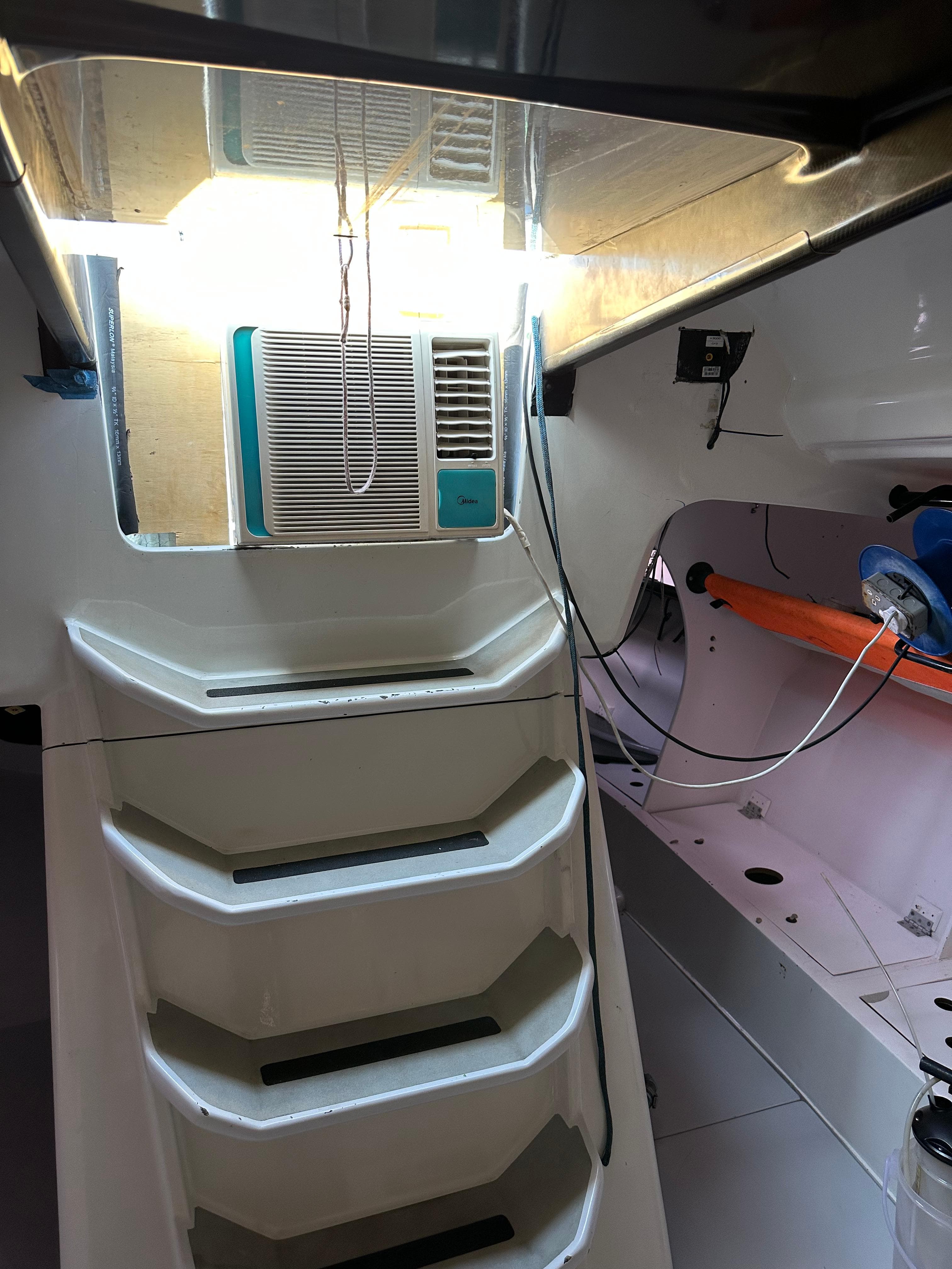 Interior of 2007 Custom Welbourn IRC/ORC 52 yacht, featuring stairs and compact air conditioning unit.