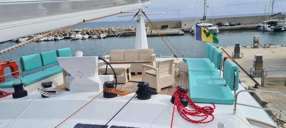 Luxurious 2022 Custom SQUALT MARINE CK 70 yacht docked, featuring spacious deck seating and vibrant ropes.