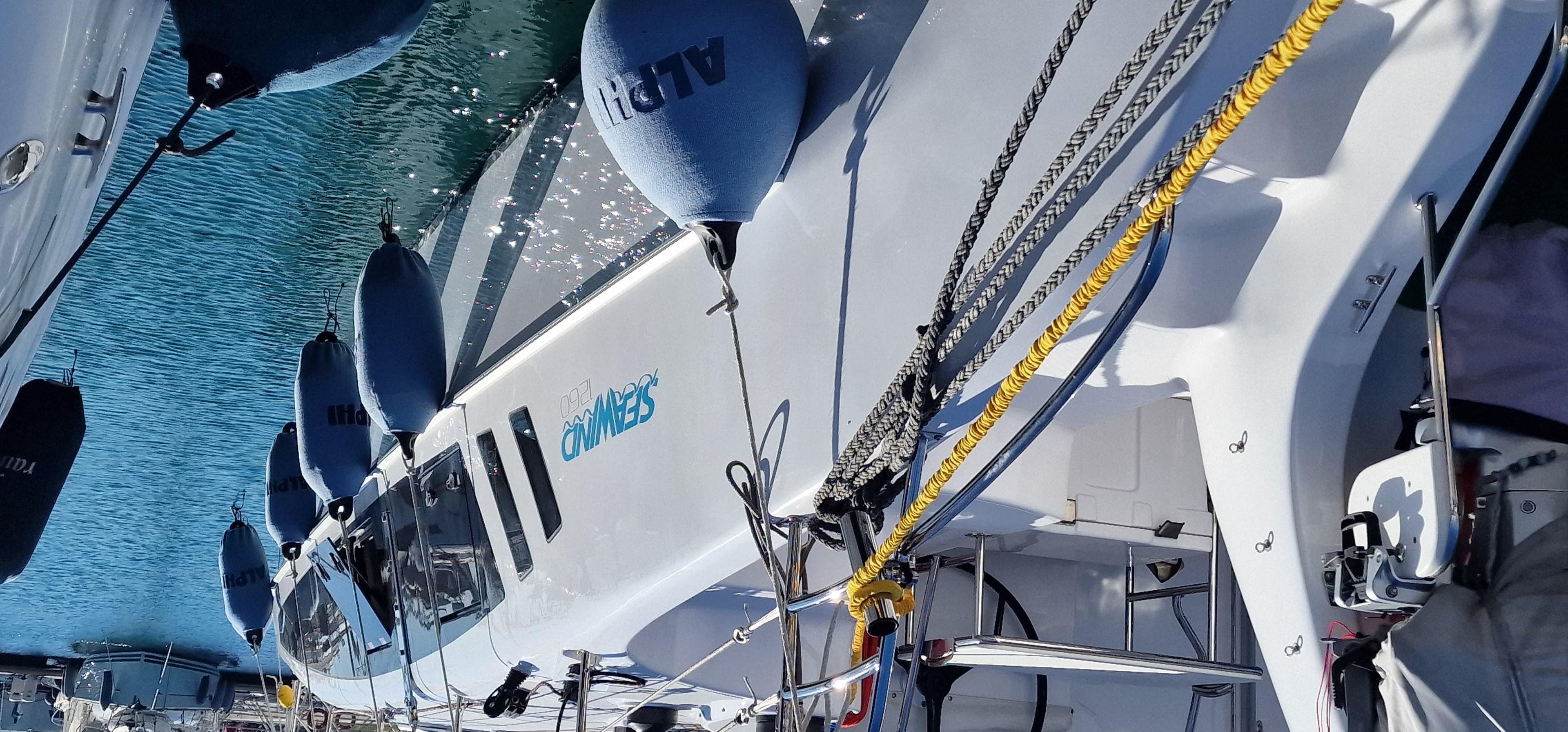 2022 Seawind 1260 catamaran docked with fenders, featuring sleek design and modern equipment.