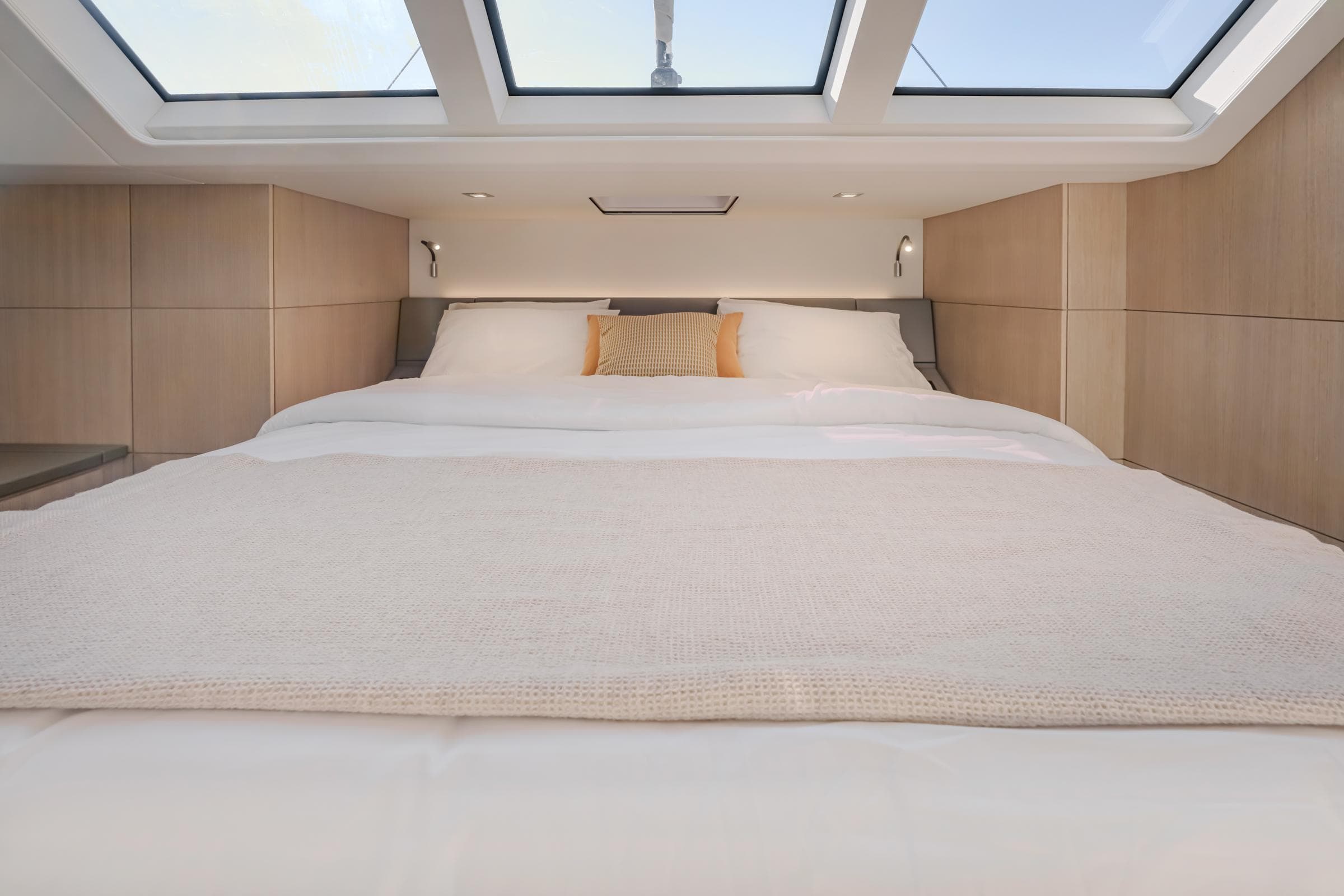 Luxurious bedroom interior of 2025 Privilege Signature 650 yacht with skylights and modern design.