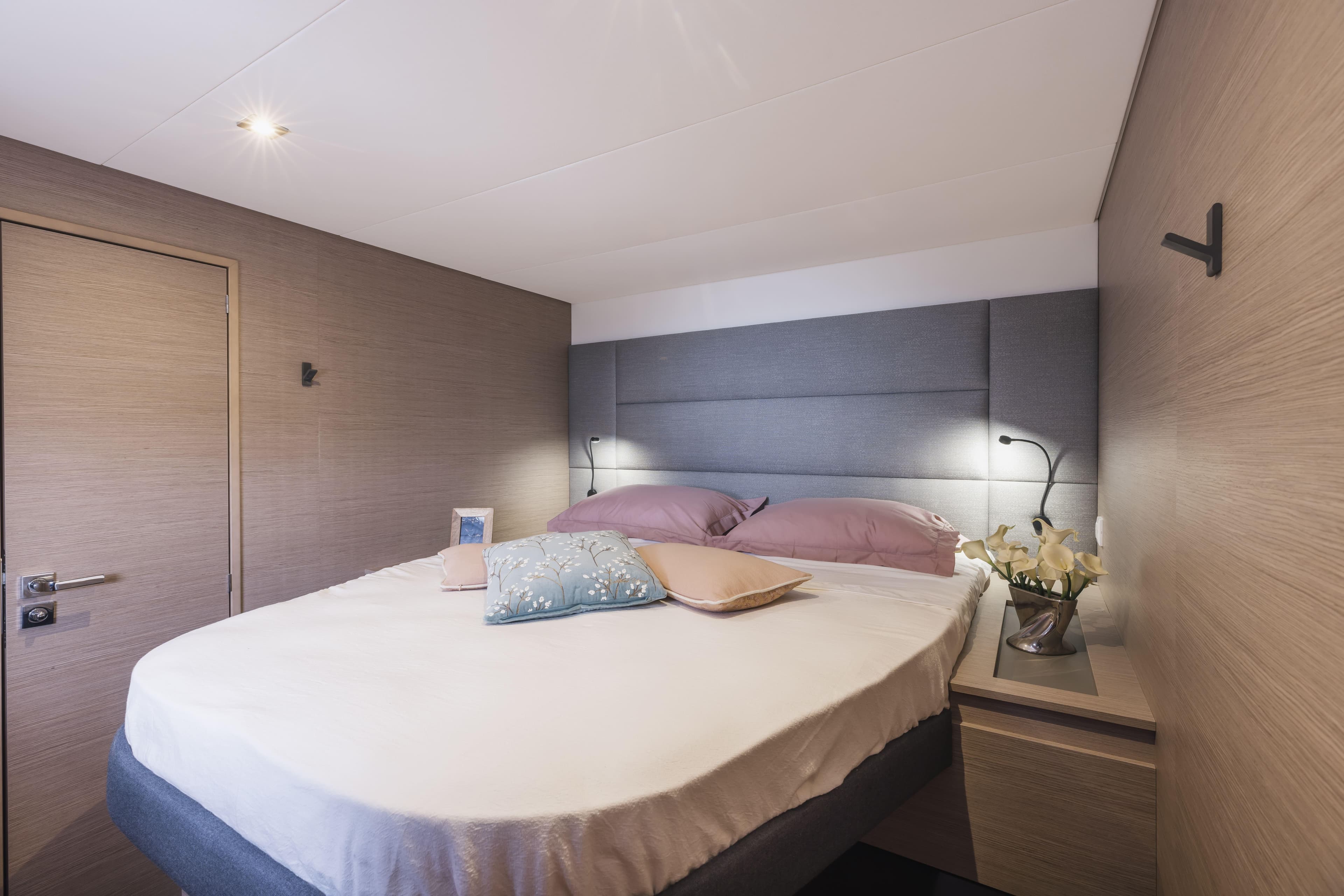 Luxurious bedroom interior of 2025 Fountaine Pajot Aura 51 yacht with modern decor.