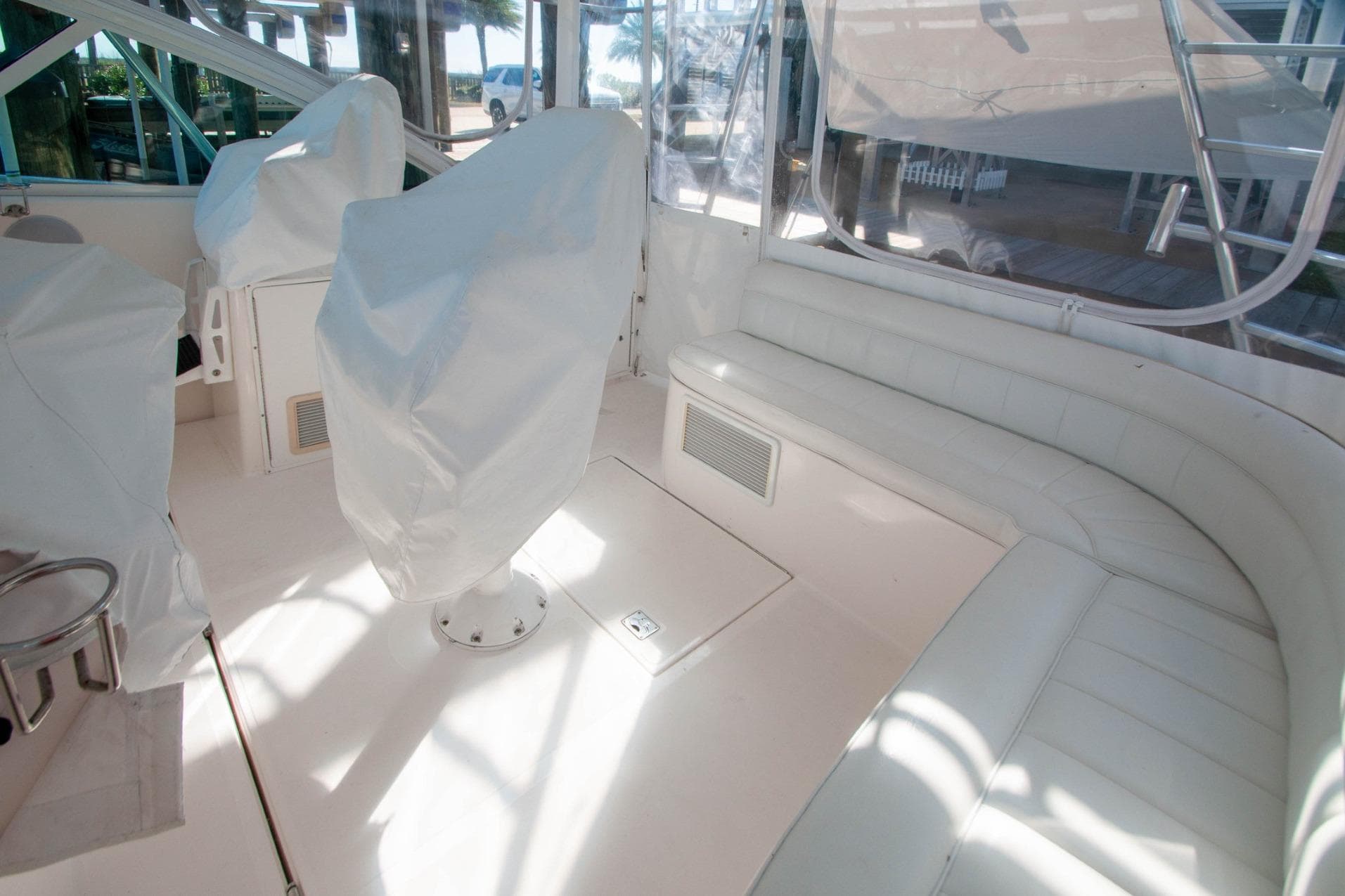 2004 Cabo 40 Express interior with covered seats and white leather seating.