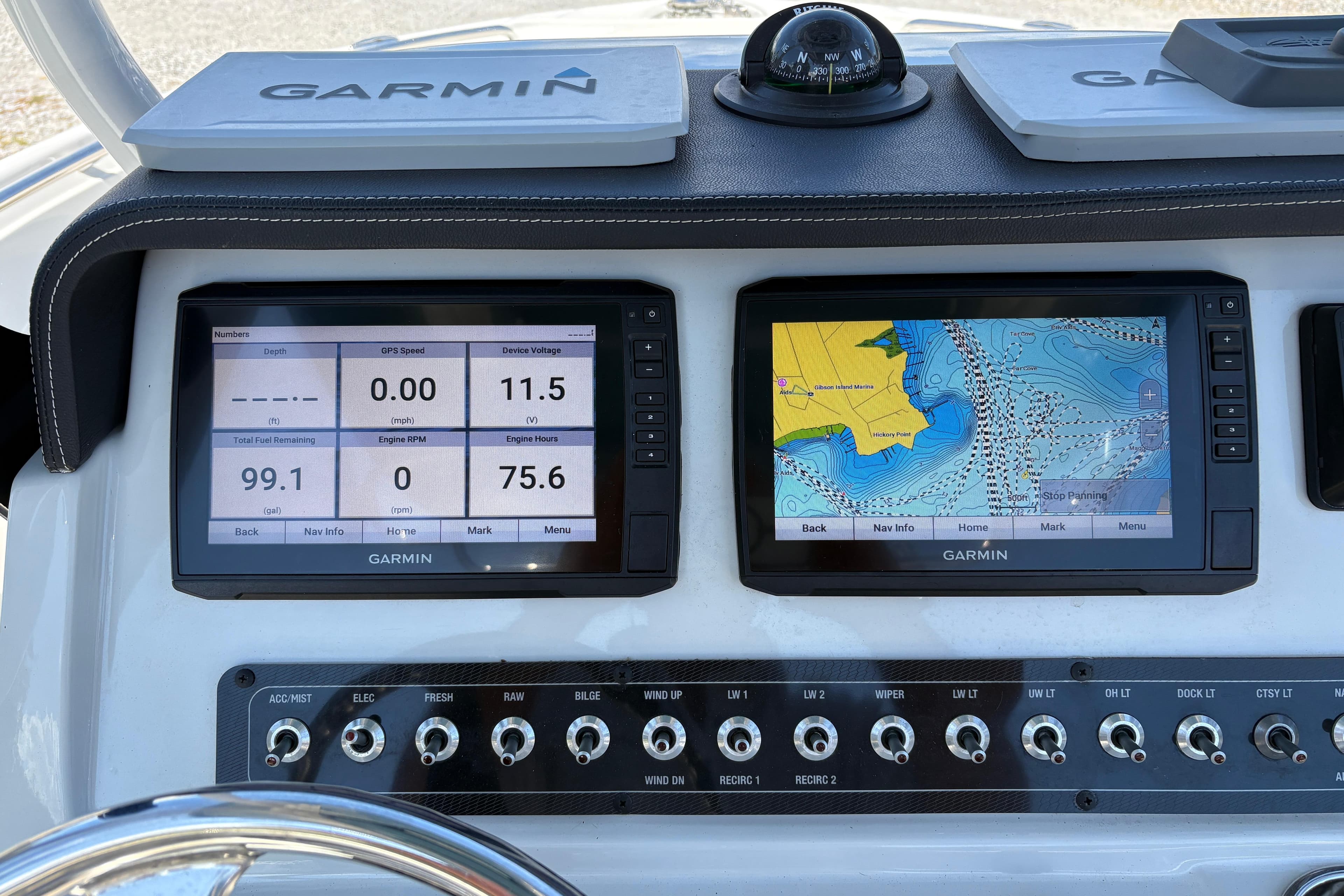 Dashboard of 2023 Finseeker 230cc boat with Garmin navigation displays.