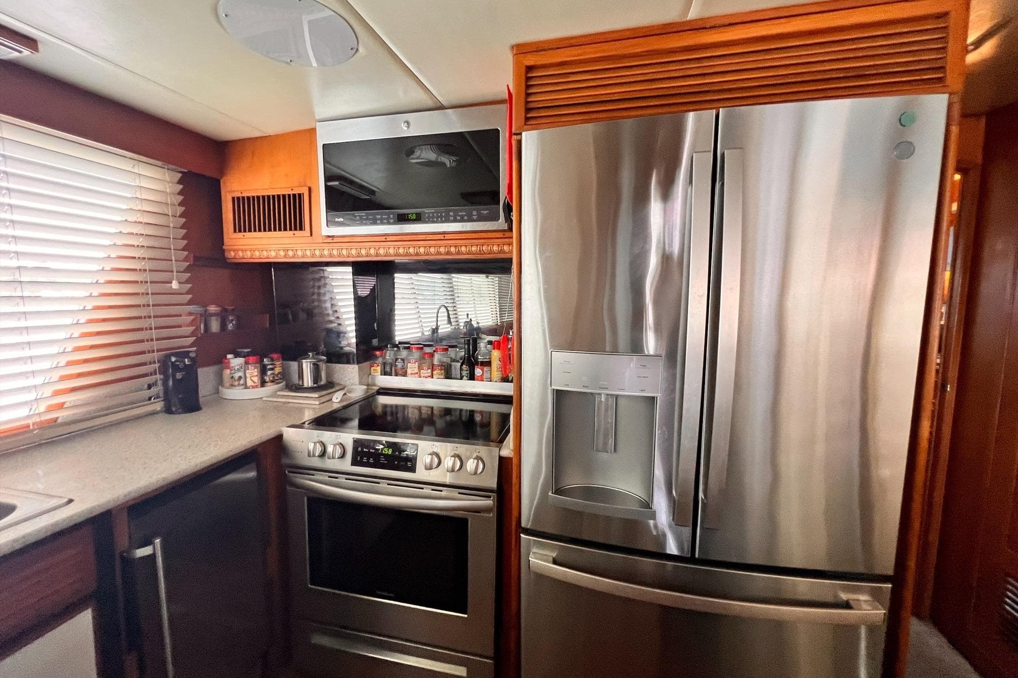 Modern kitchen in 1985 Hartman-Palmer 60 Flush Deck Motor Yacht with stainless steel appliances.
