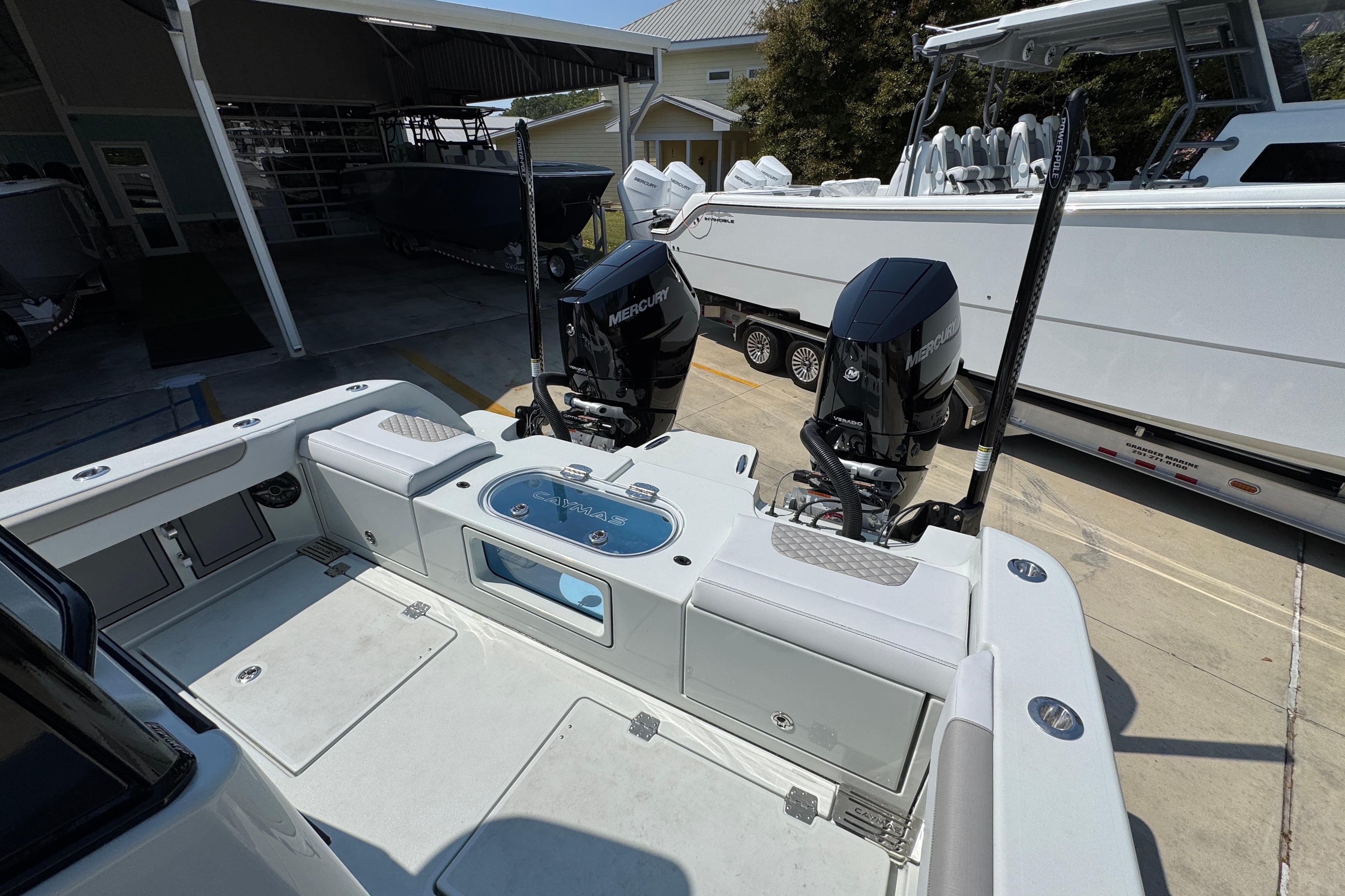 2026 Caymas 29 CT boat with dual Mercury engines at a marina.