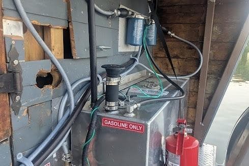 Engine compartment of a 2016 custom pirate ship with gasoline tank and fire extinguisher.