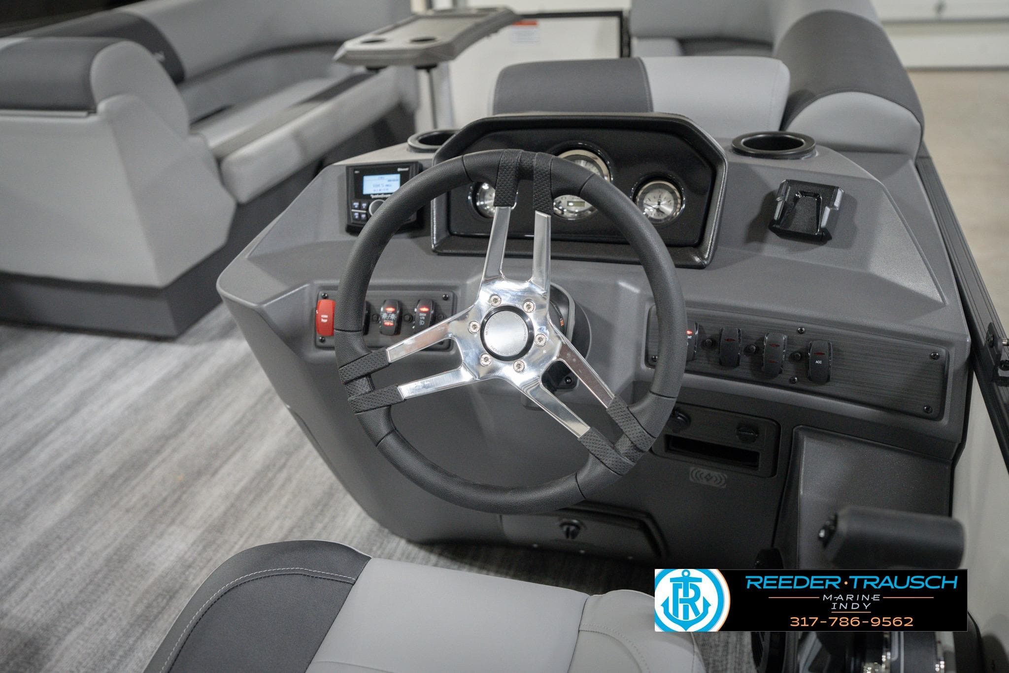 2026 Bennington 22 SSB boat dashboard with steering wheel and control panel.