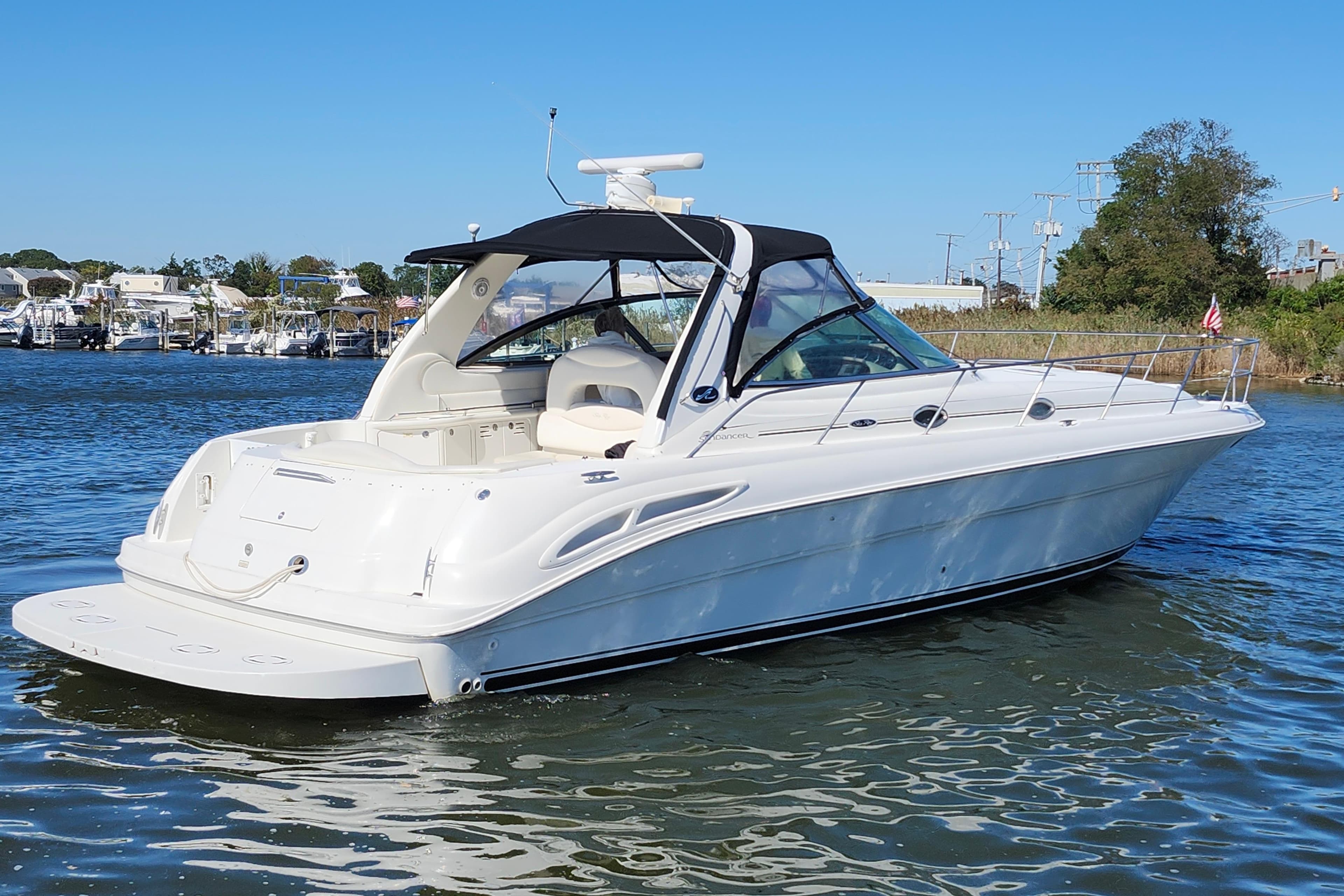 2002 Sea Ray 410 Sundancer yacht on calm water, featuring sleek design and spacious deck.