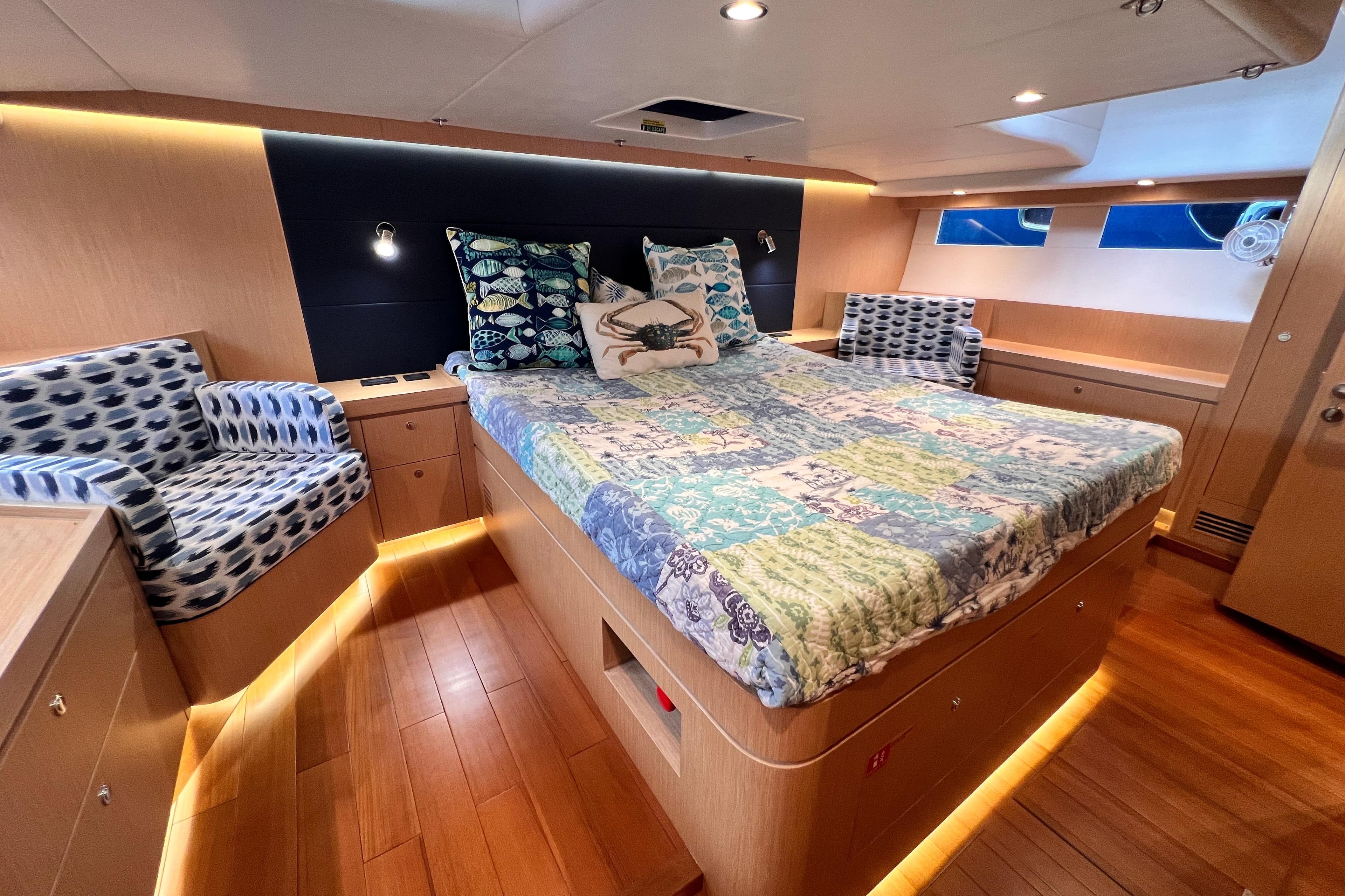 Luxurious 2024 Hylas H57 yacht cabin with elegant bedding and ambient lighting.