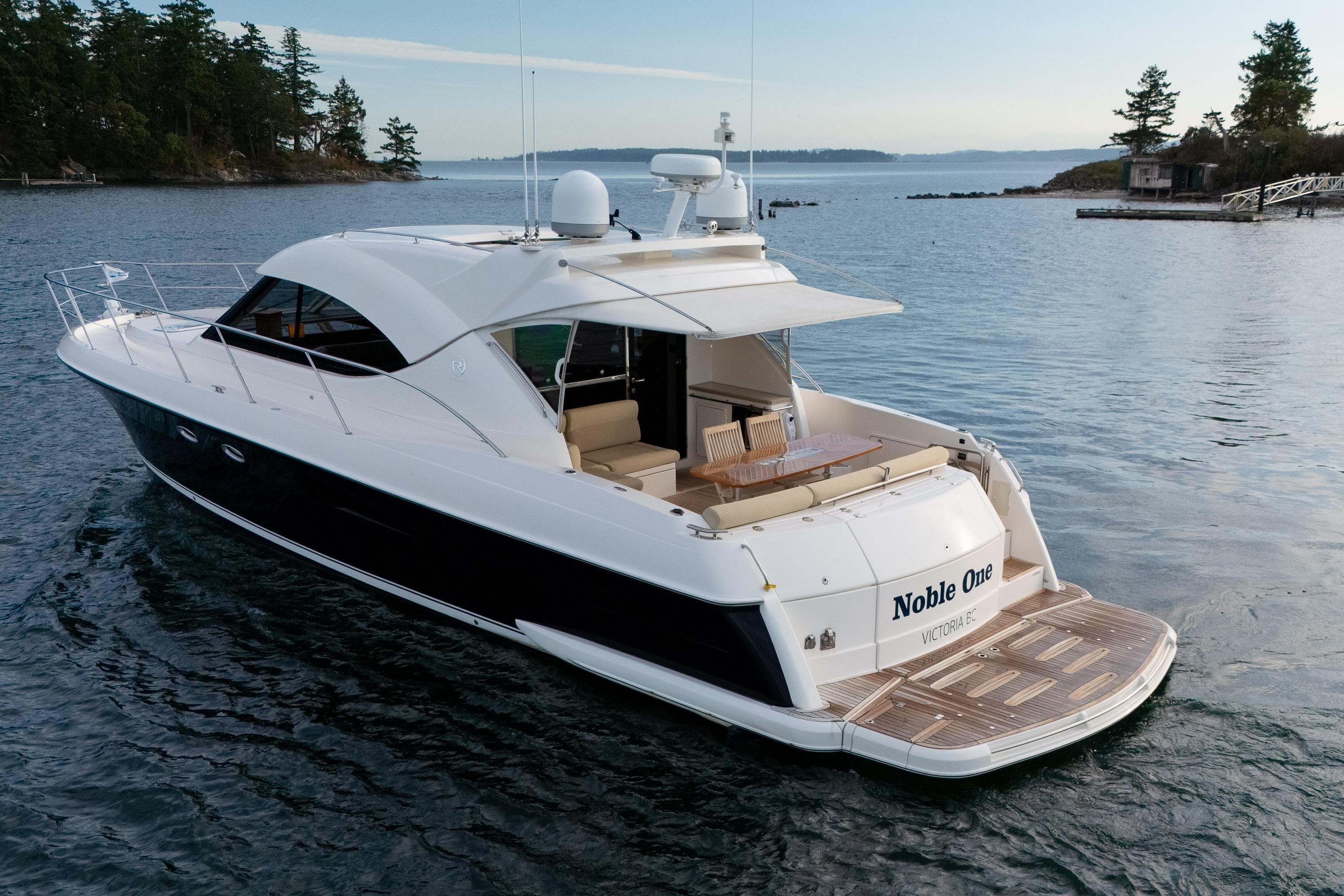 2011 Riviera 5000 Sport Yacht on serene water, featuring sleek design and spacious deck.
