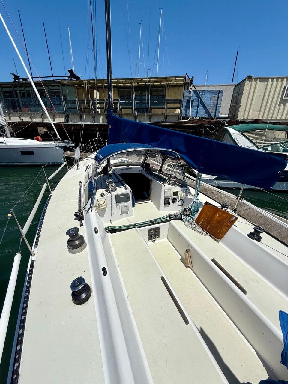 1985 Alsberg Brothers Express 37 sailboat docked, featuring a spacious cockpit and blue sail cover.