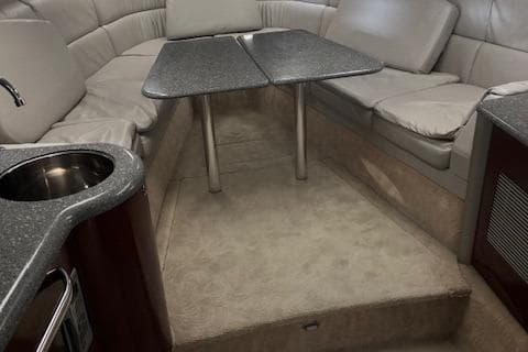 2005 Formula 400 SS cabin interior with seating, table, and kitchenette.