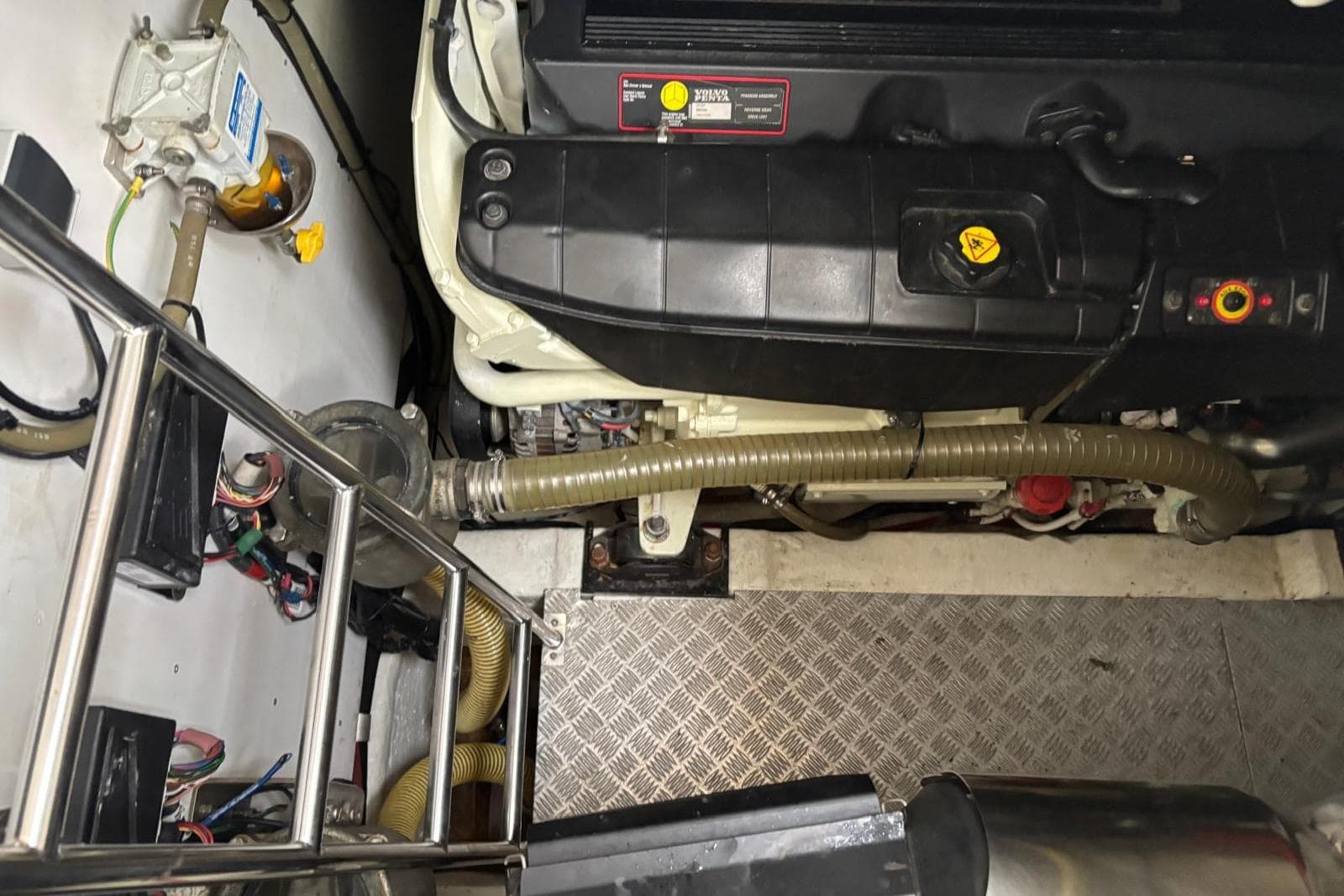 Engine room of a 2006 Princess V48 yacht, featuring mechanical components and wiring.