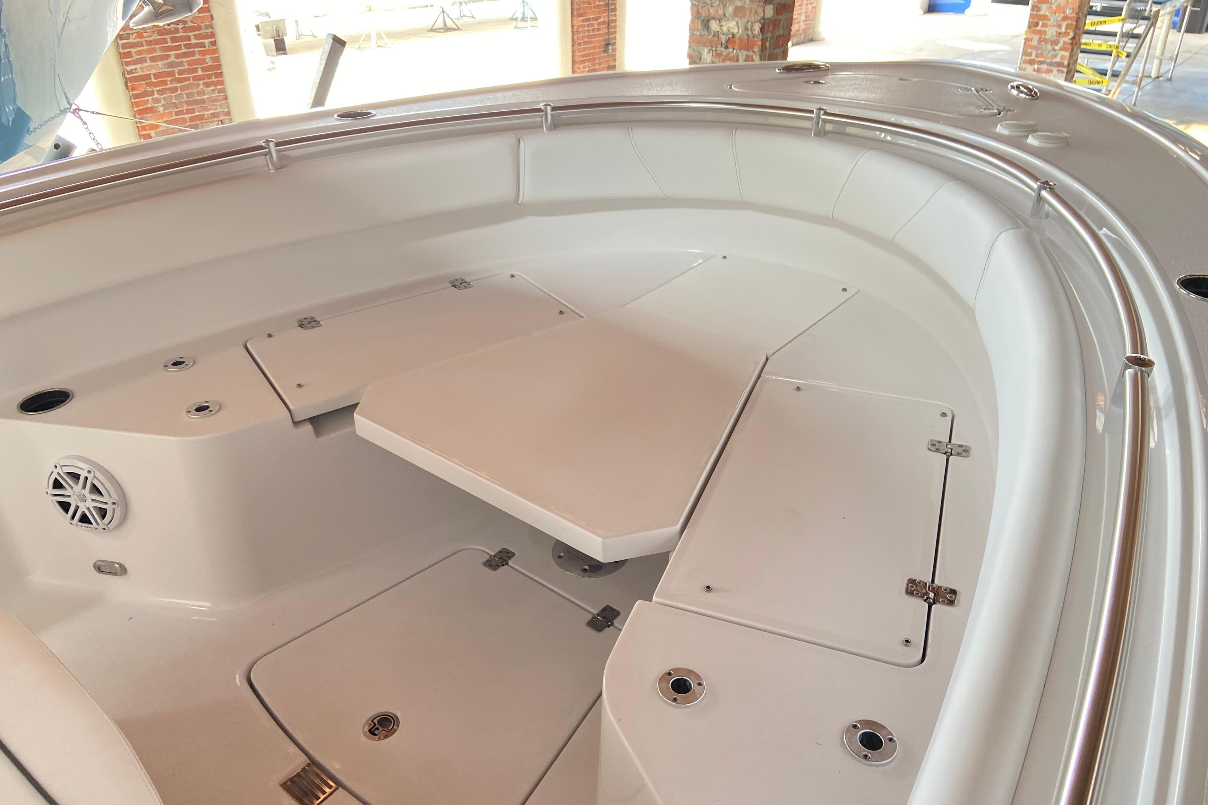 2026 Sportsman Open 232 Center Console boat interior with seating and storage compartments.
