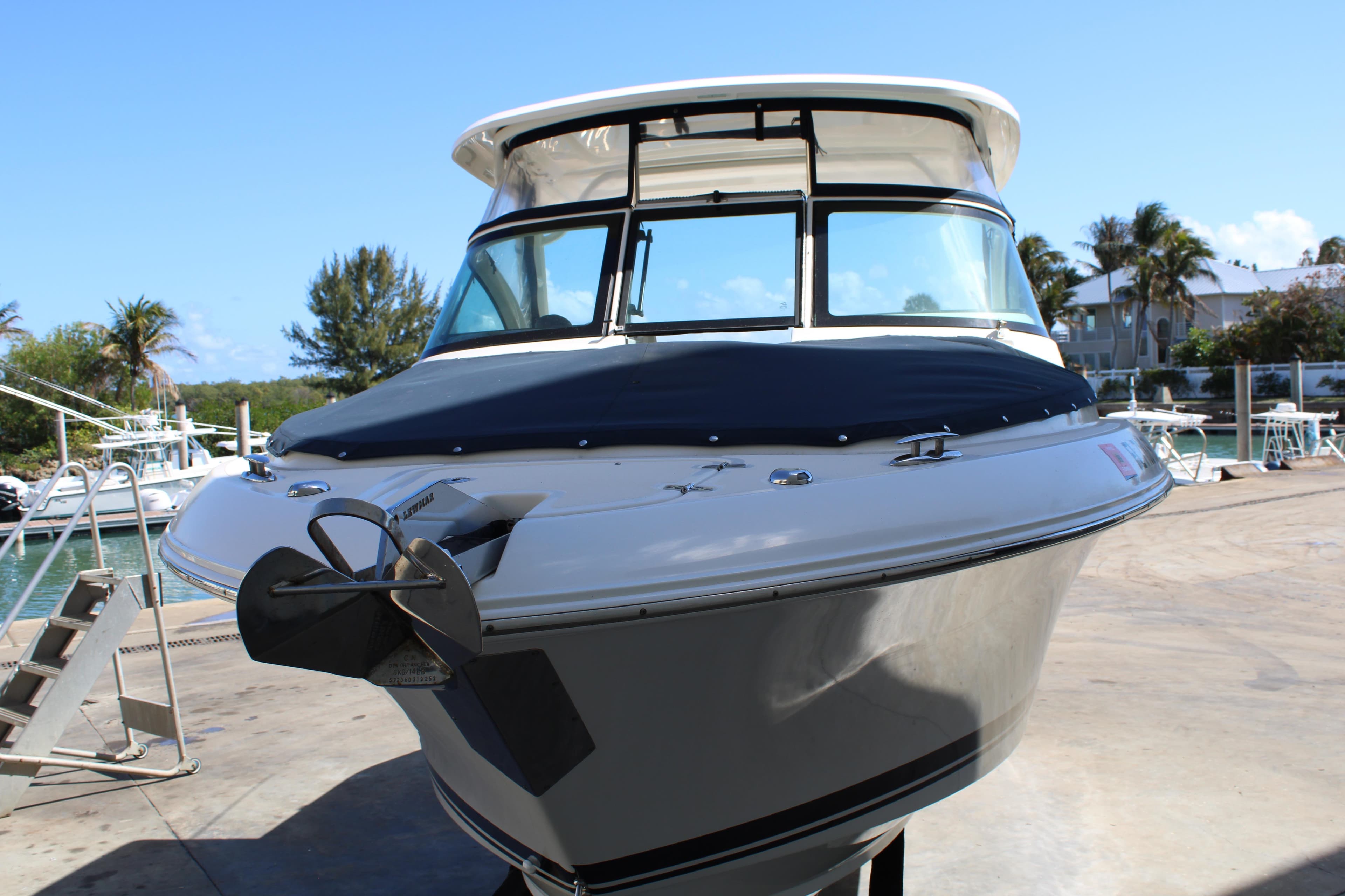 2020 Pursuit DC 235 Dual Console boat docked with scenic background.
