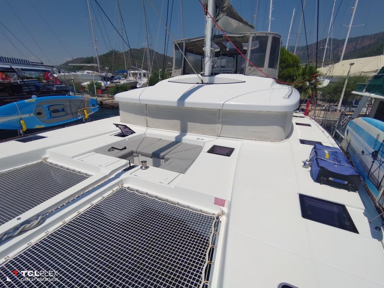 2014 Lagoon 52 catamaran deck with netting, docked at marina.