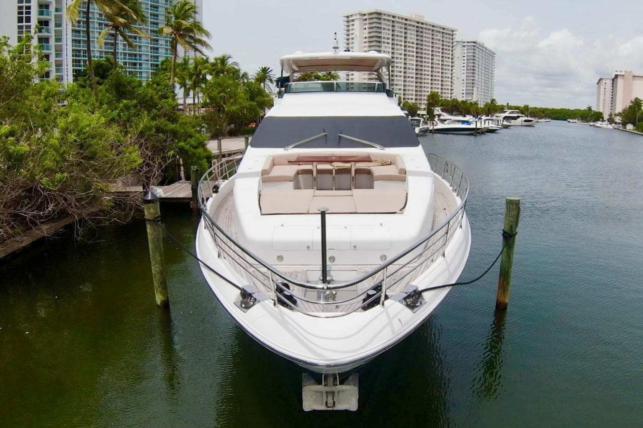Luxurious 2015 Azimut 84 yacht docked in a scenic marina setting.