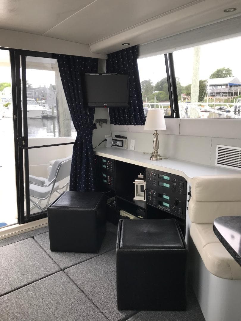 1990 Mainship Mediterranean yacht interior with seating, control panel, and window view.