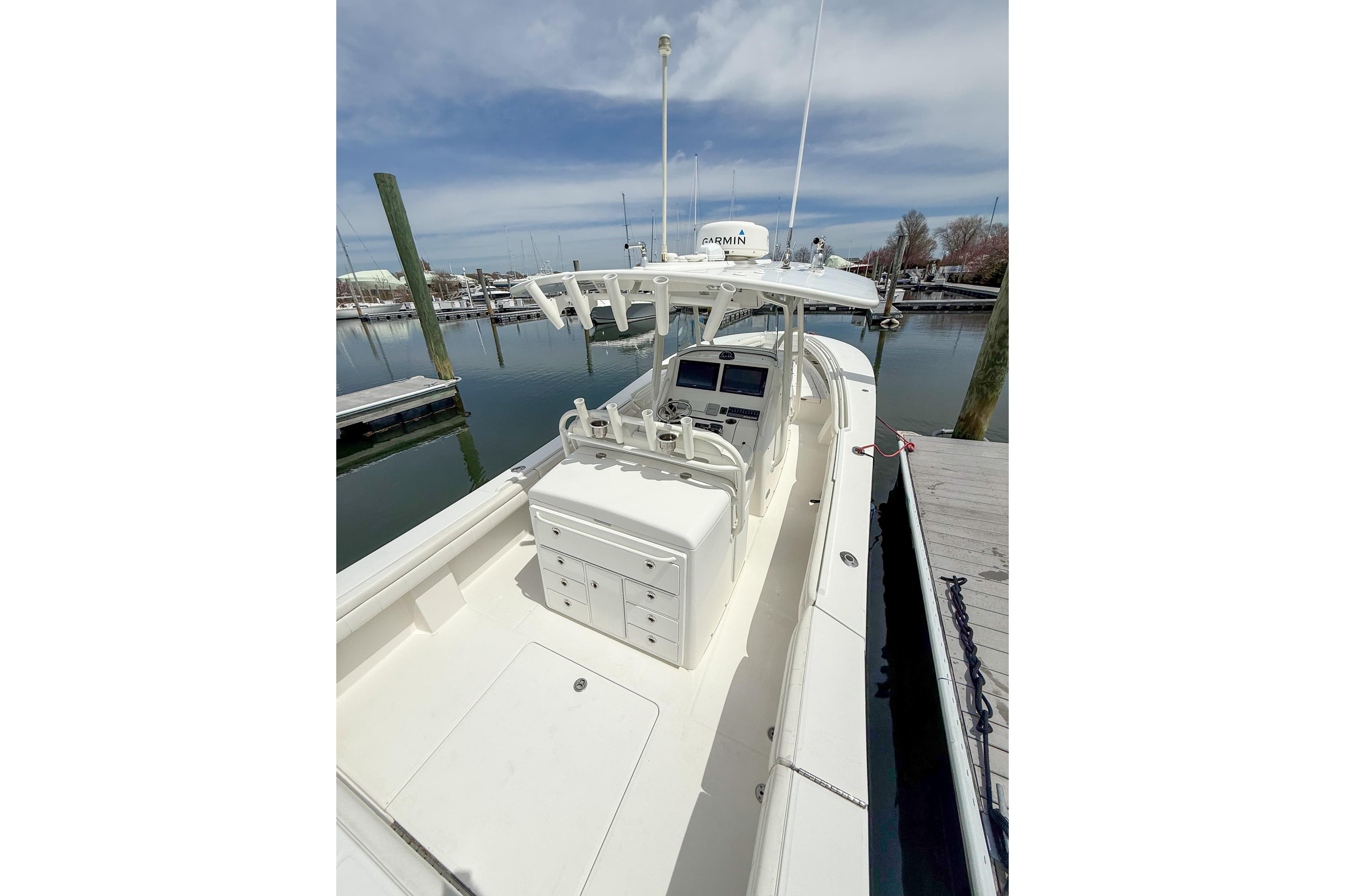 2017 Regulator 31 boat docked, featuring a spacious deck and modern navigation equipment.