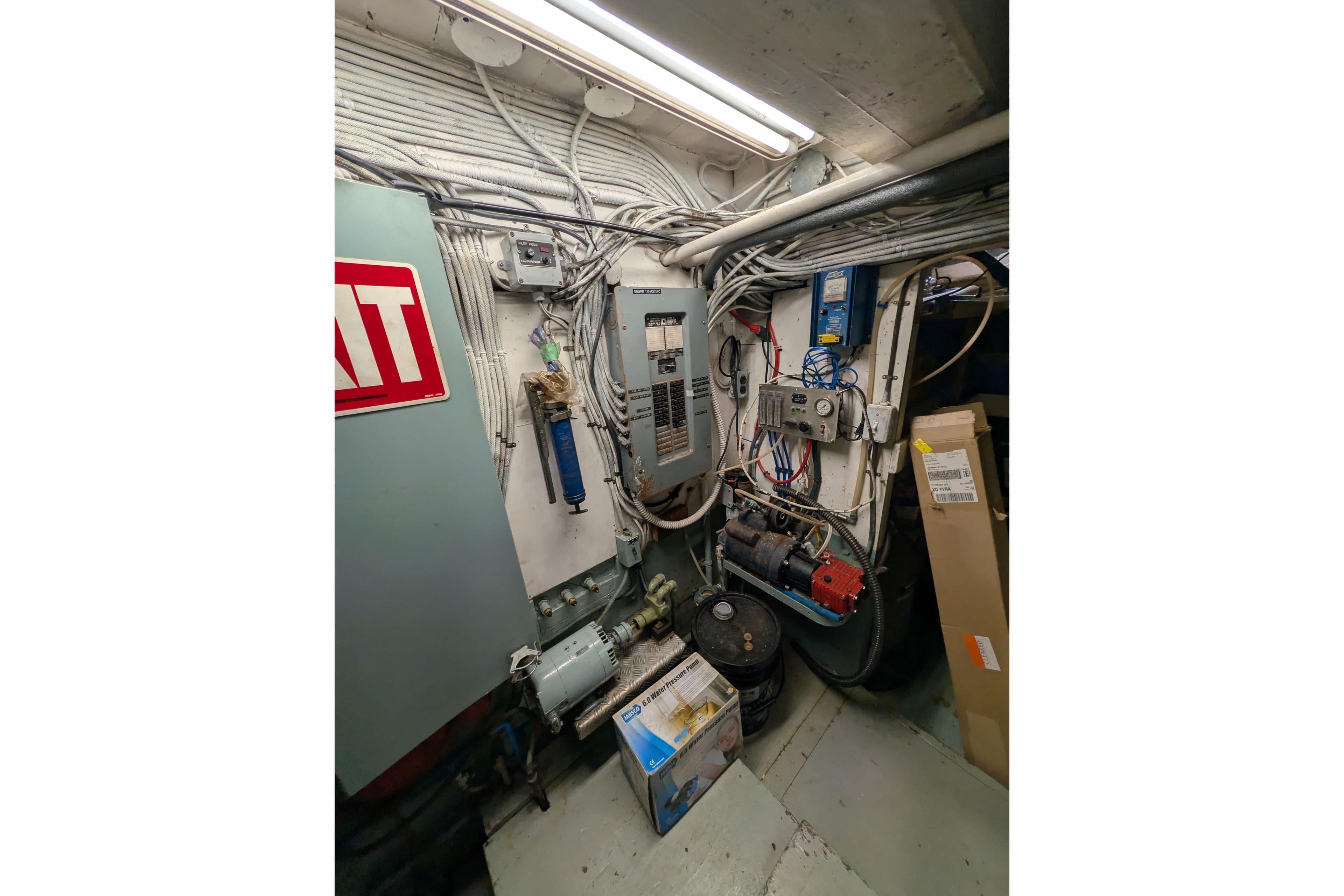 Engine room of 1941 Armstrong Marine Custom Wooden Trawler, featuring electrical panels and equipment.