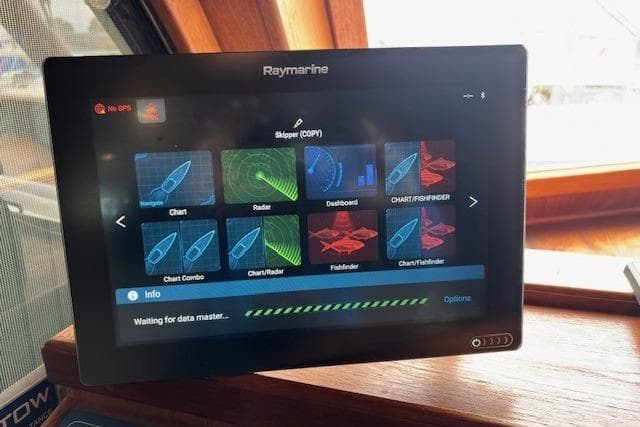 Raymarine navigation display on 1983 Canoe Cove Sedan Bridge, showing charts and radar interface.