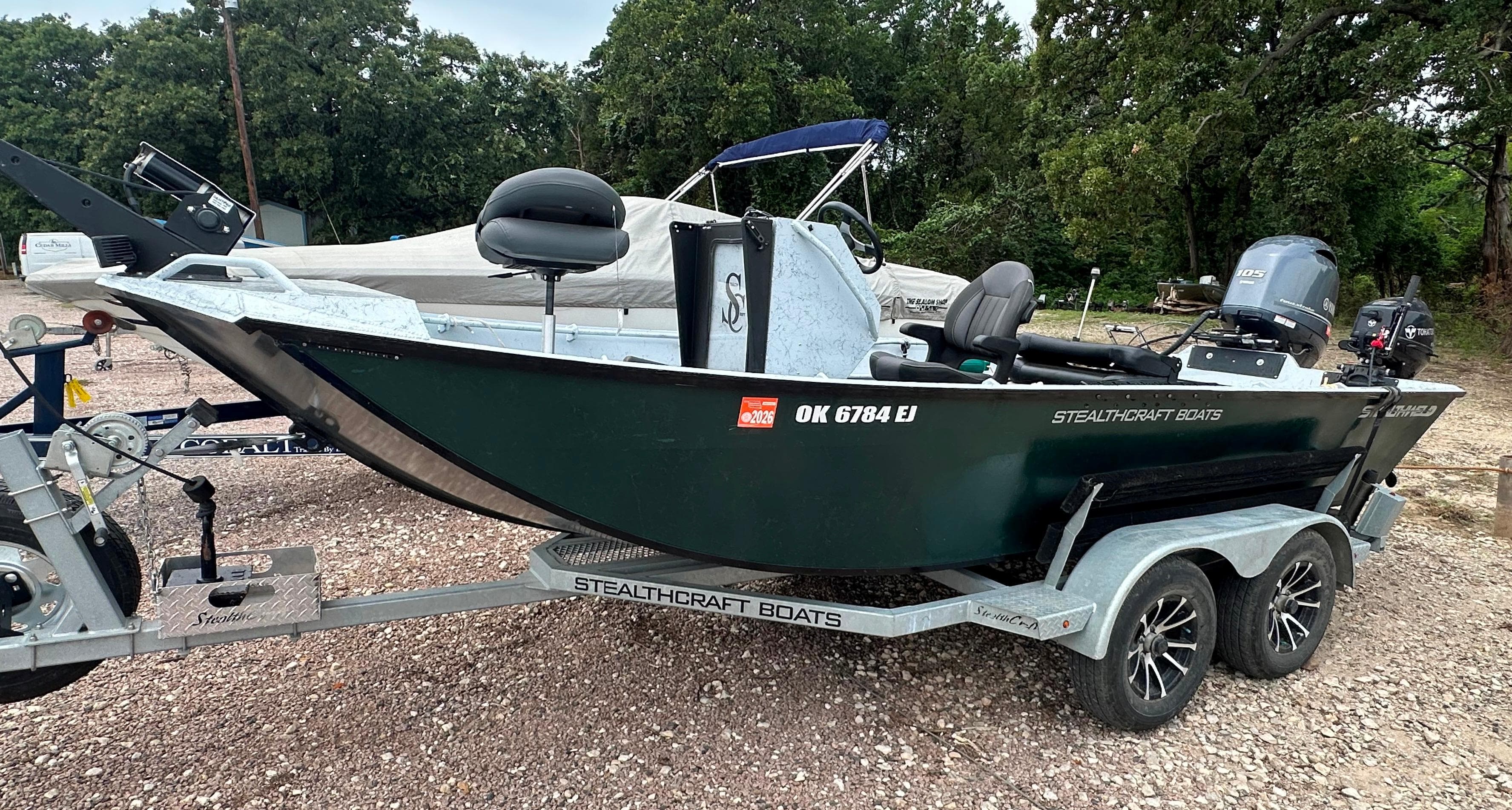 2023 StealthCraft Stealthweld 18 boat on trailer, parked outdoors.