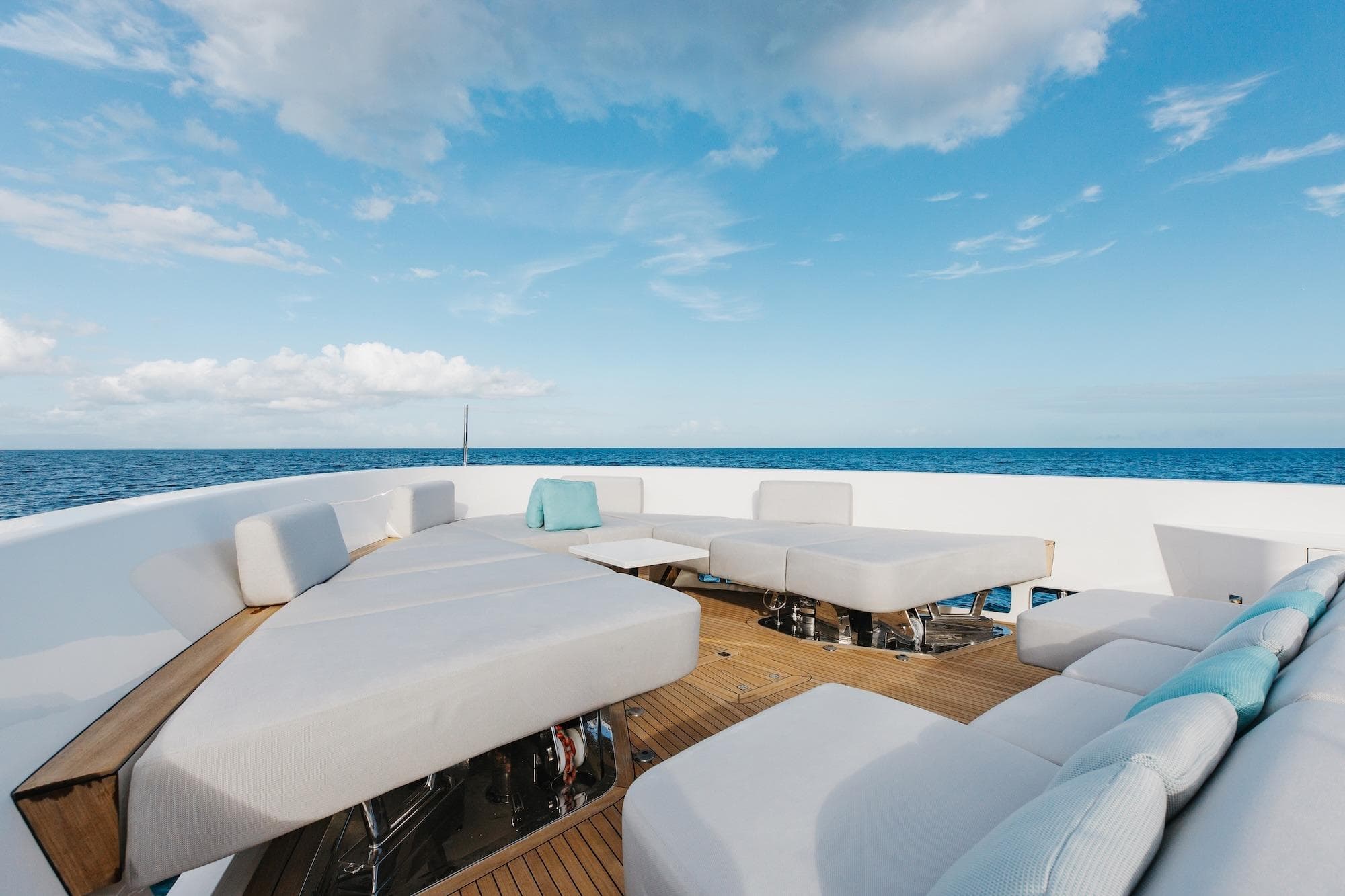 Luxurious Sanlorenzo SLA120A yacht deck with modern seating, ocean view, and blue sky, 2020 model.