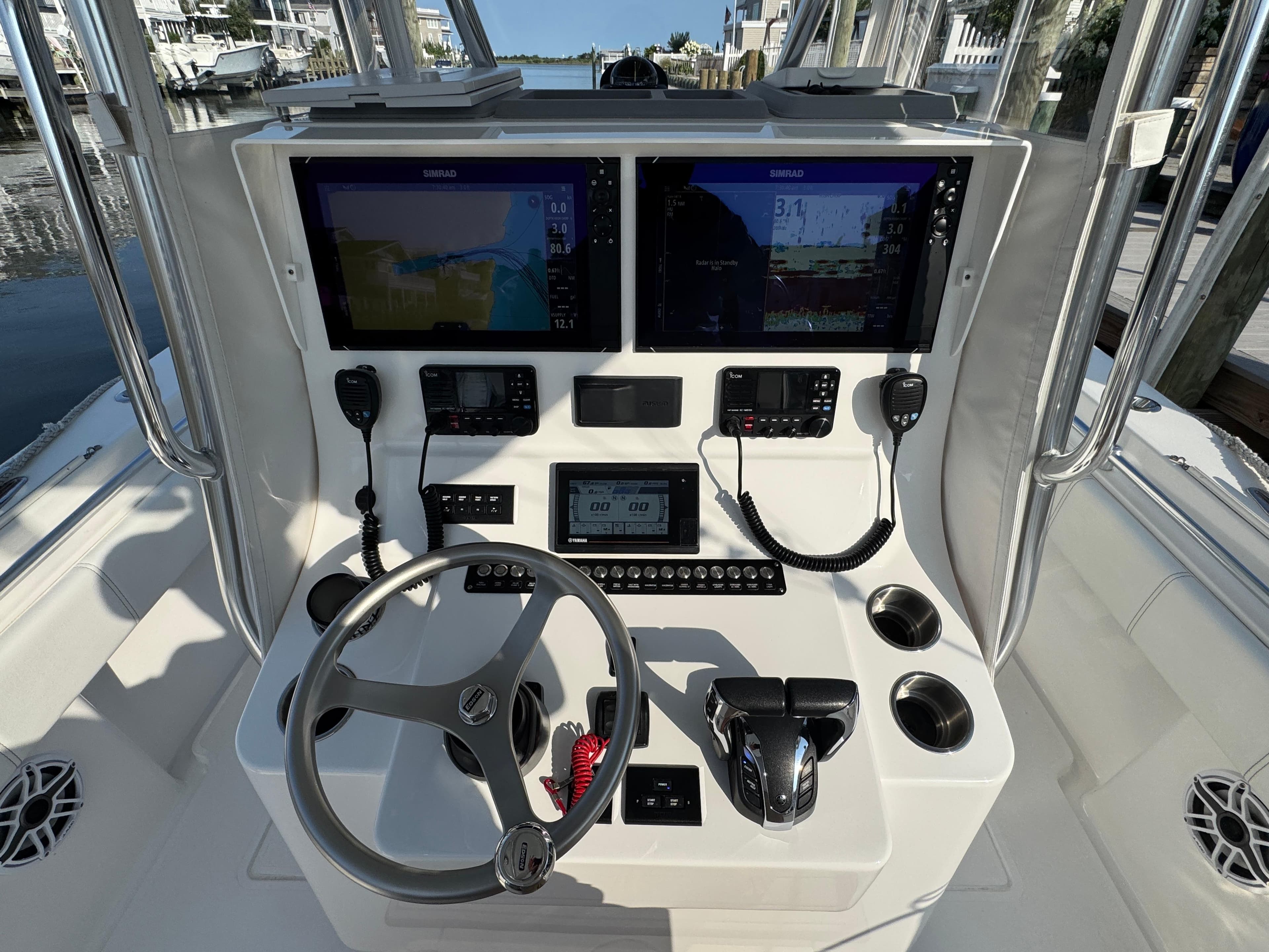 2022 Contender 32 ST boat console with dual Simrad displays and steering wheel.