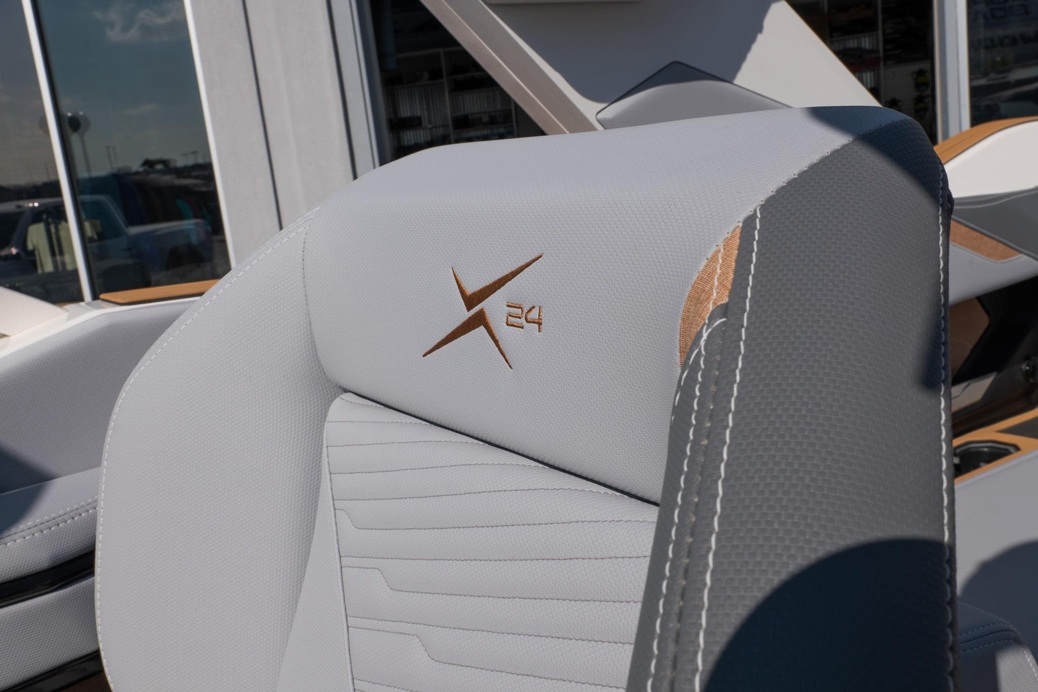2026 MasterCraft X24 boat seat with logo, featuring sleek gray upholstery.