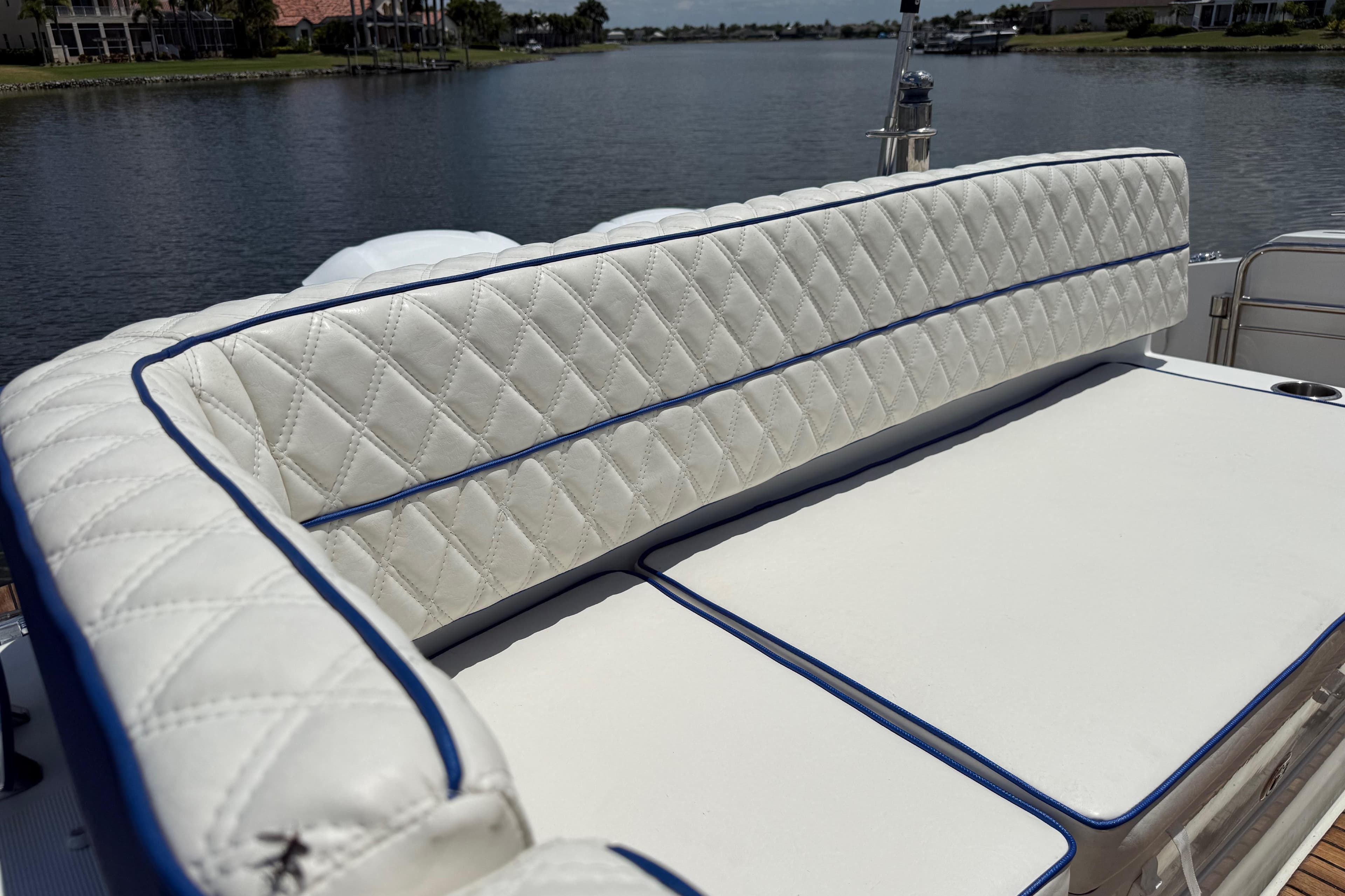 Luxurious seating on 2019 Jeanneau Leader 10.5 boat, overlooking serene waterway.