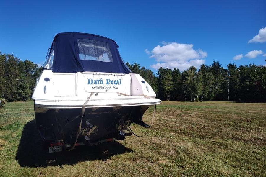 2009 Fountain 38 Express Cruiser "Dark Pearl" on grassy field, clear sky background.