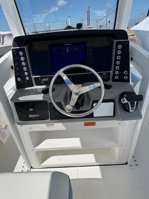 2025 Robalo 246 Cayman boat dashboard with steering wheel and control panel.