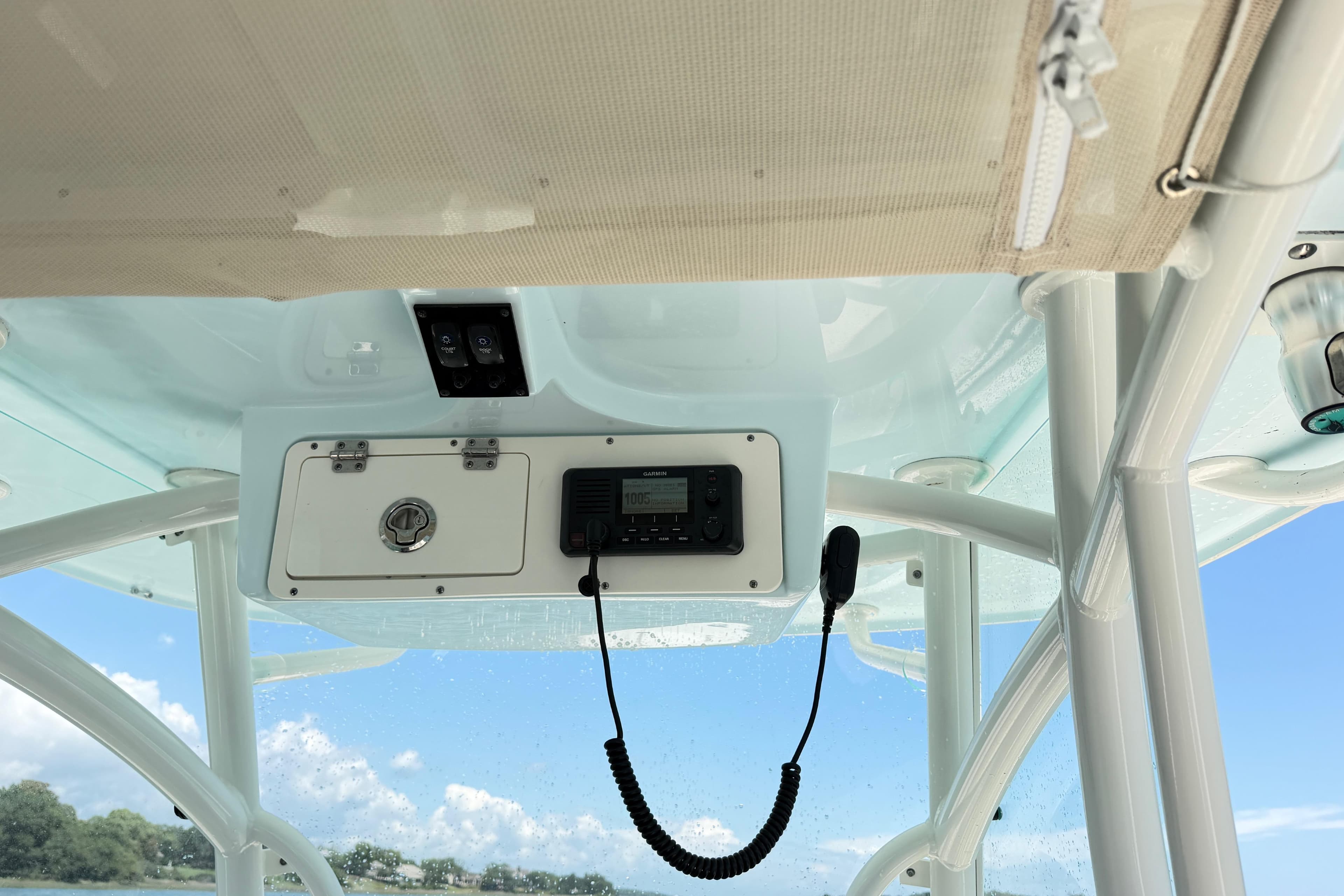 Interior view of 2021 Sailfish 290 CC boat's control panel under a clear sky.