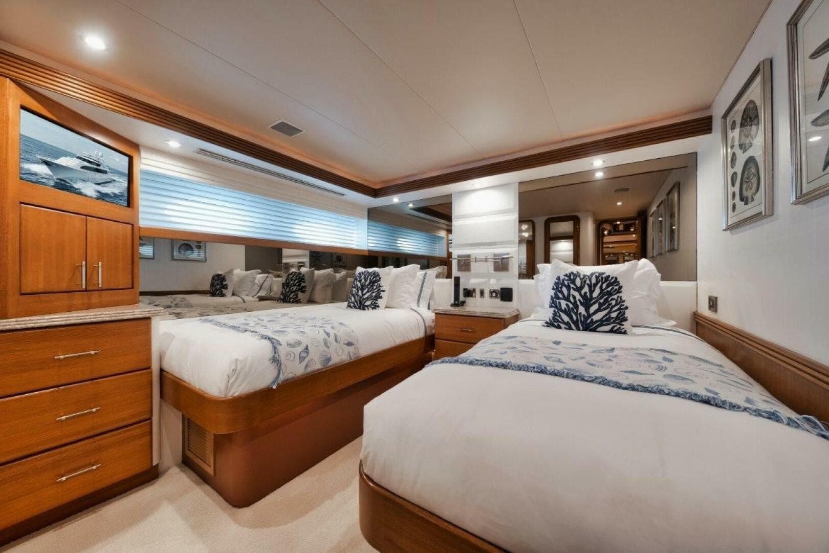 Luxurious twin bedroom on 2002 Westport 112 yacht, featuring elegant decor and modern amenities.