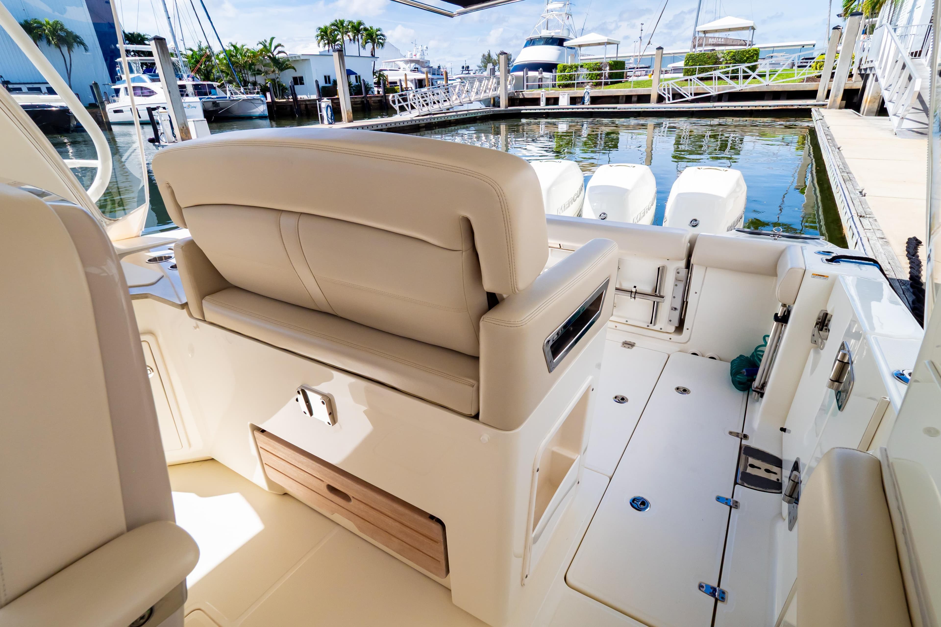 2019 Boston Whaler 350 Realm boat interior with beige seating at marina.