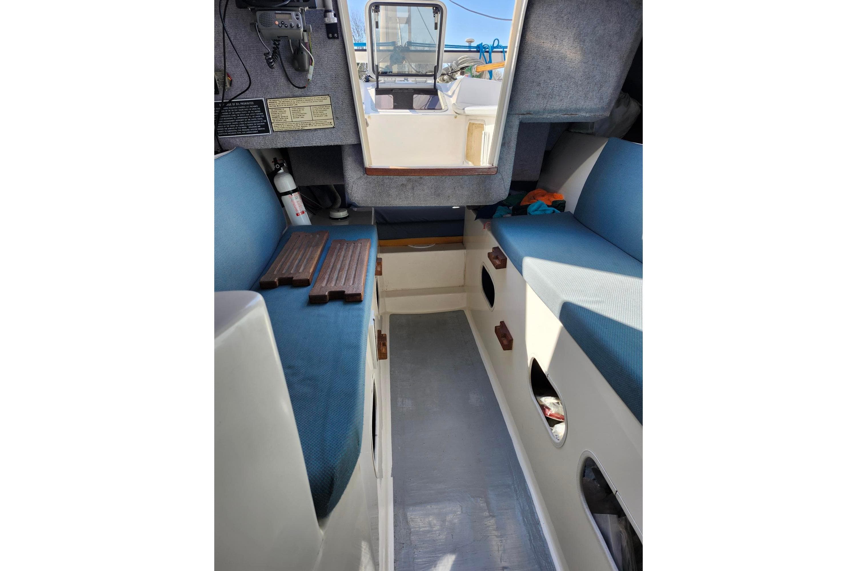 Interior of a 2000 Farrier 31 boat with blue seating and storage compartments.