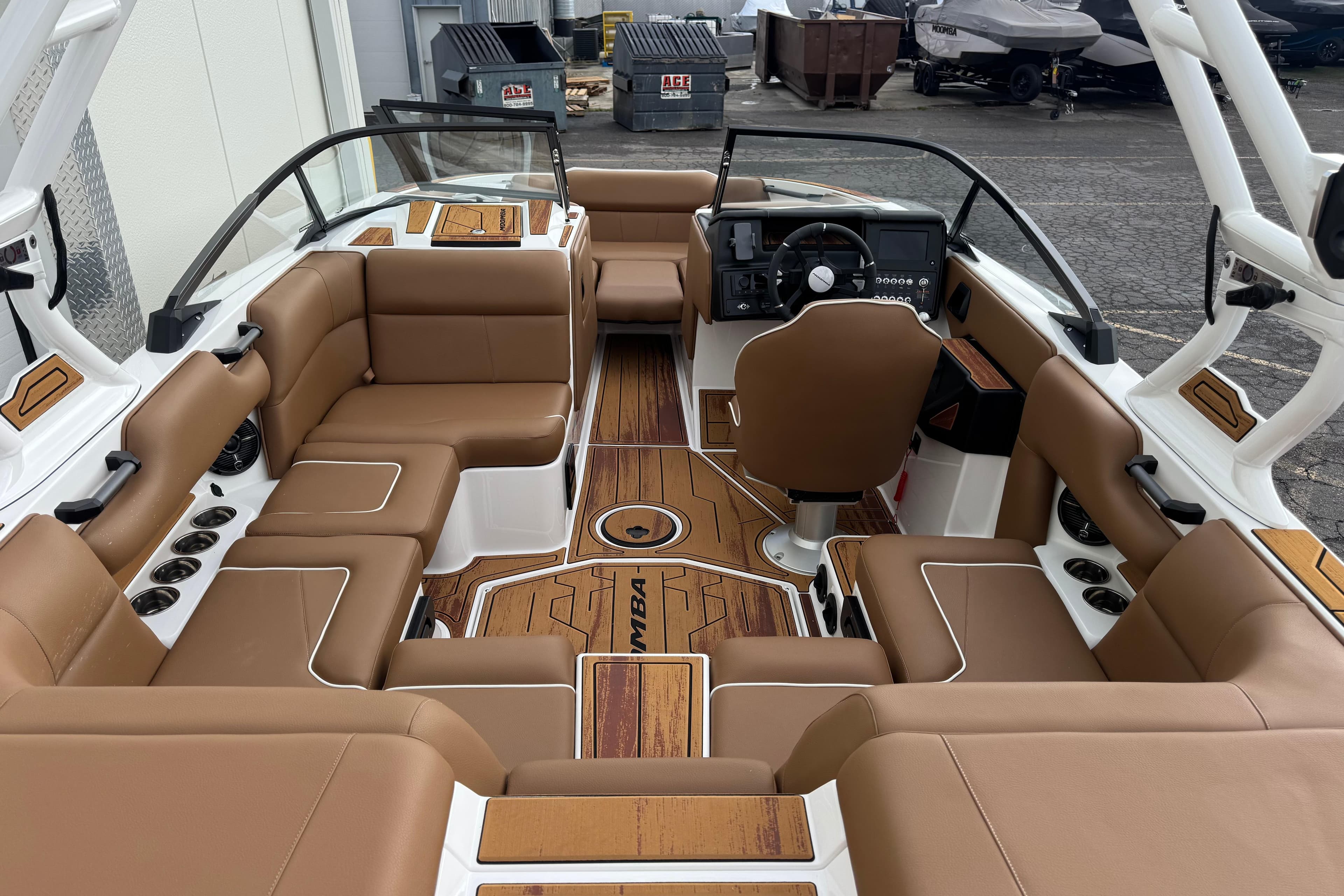 2026 Moomba Mondo boat interior with brown leather seating and modern dashboard.