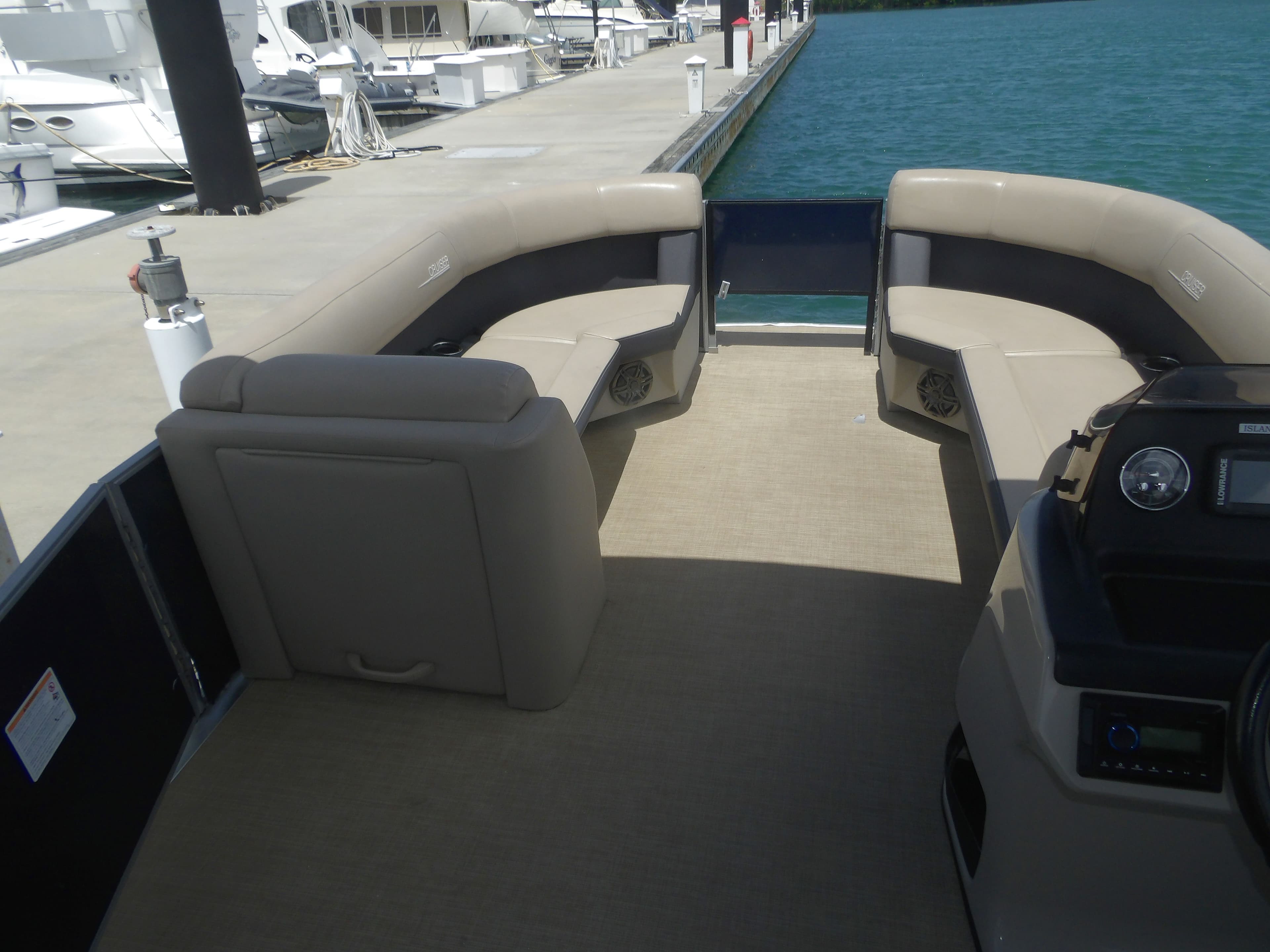 Interior of a 2024 Harris Pontoon boat at the dock.
