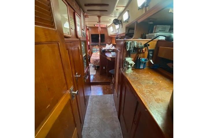 Interior of 1982 Endeavour 40 sailboat with wooden cabinetry and cozy living space.