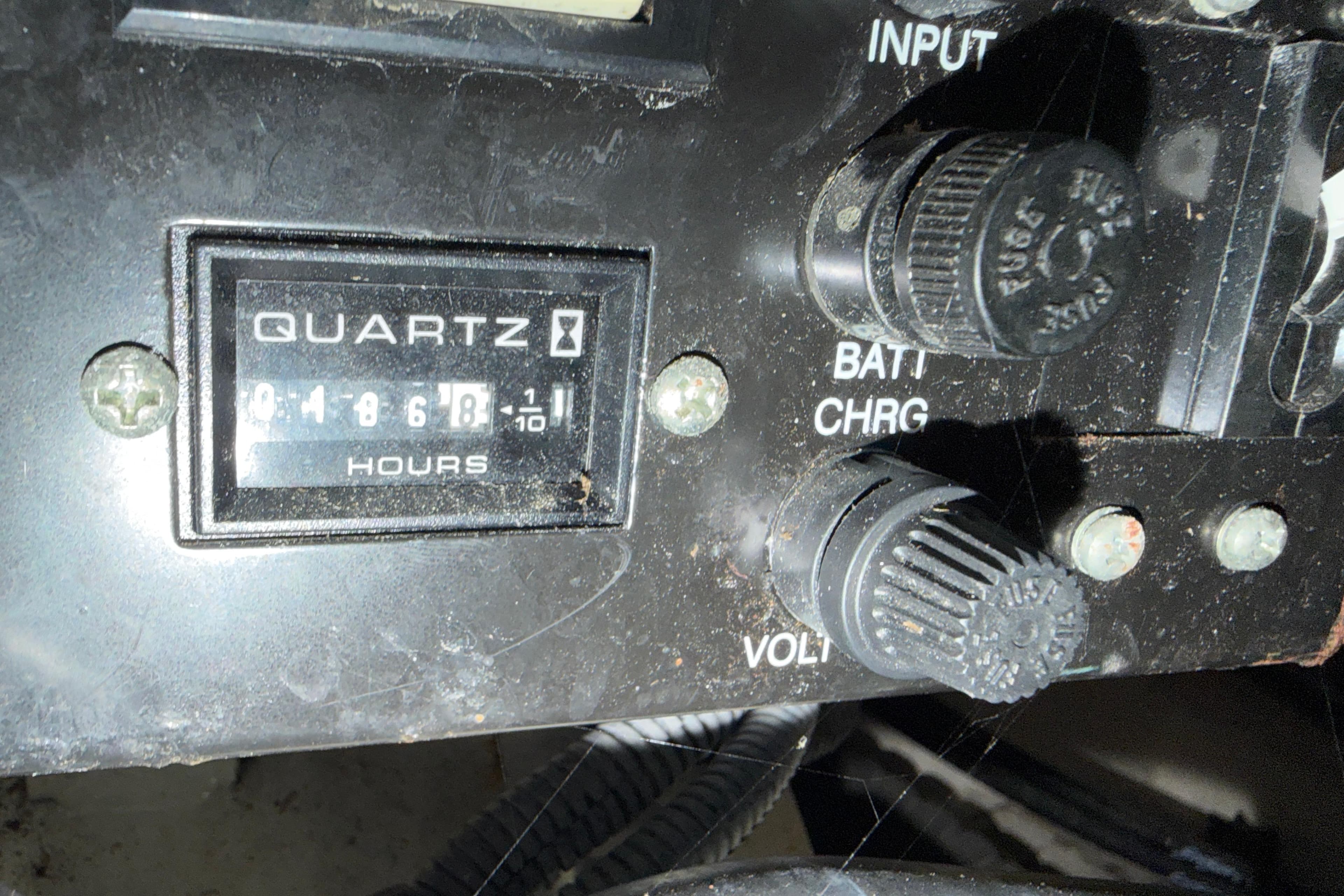 Control panel of a 2006 Sea Ray 340 Sundancer with hour meter and knobs.