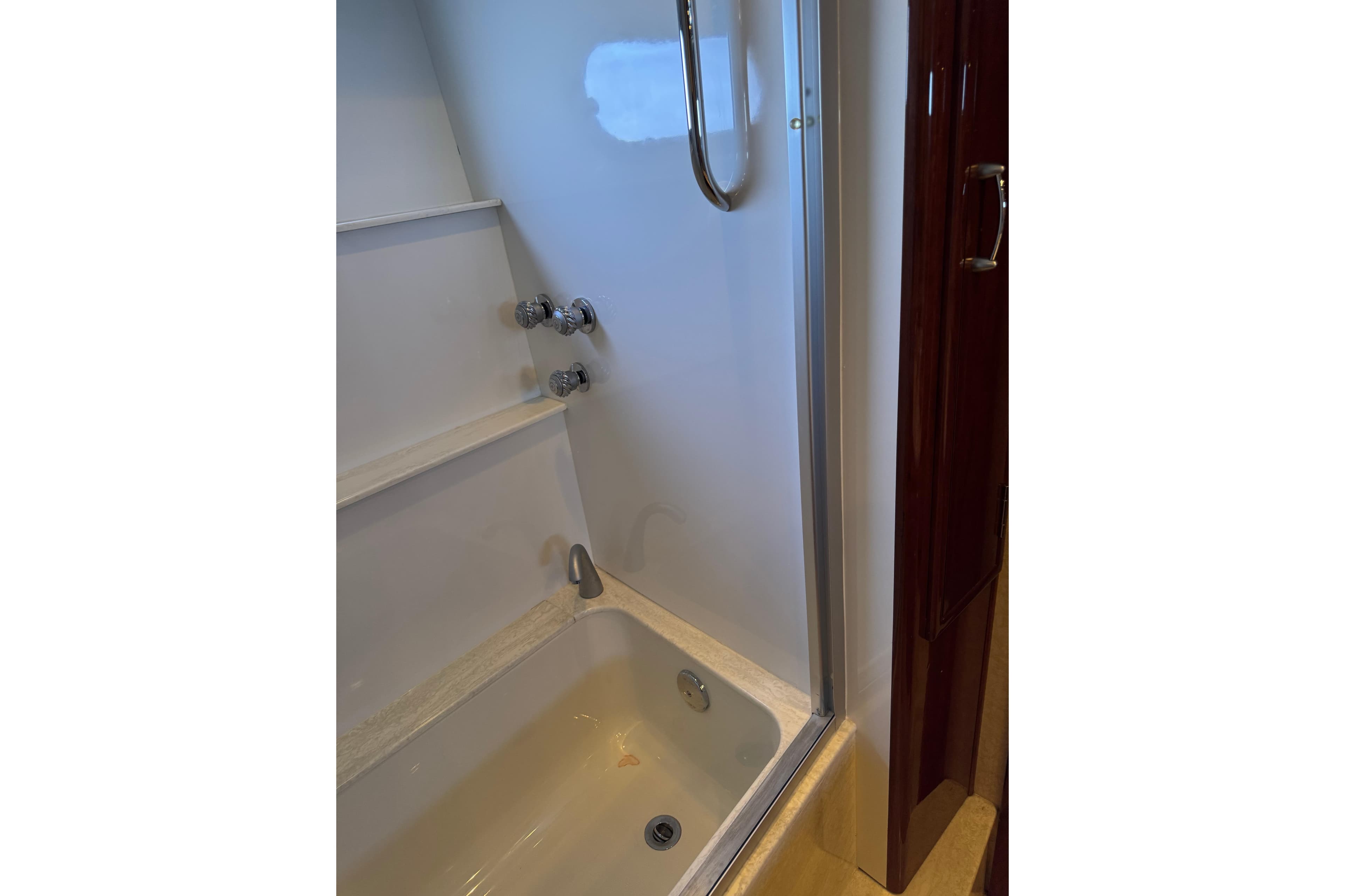 Bathtub with chrome fixtures in 2006 Marquis 59 yacht bathroom.