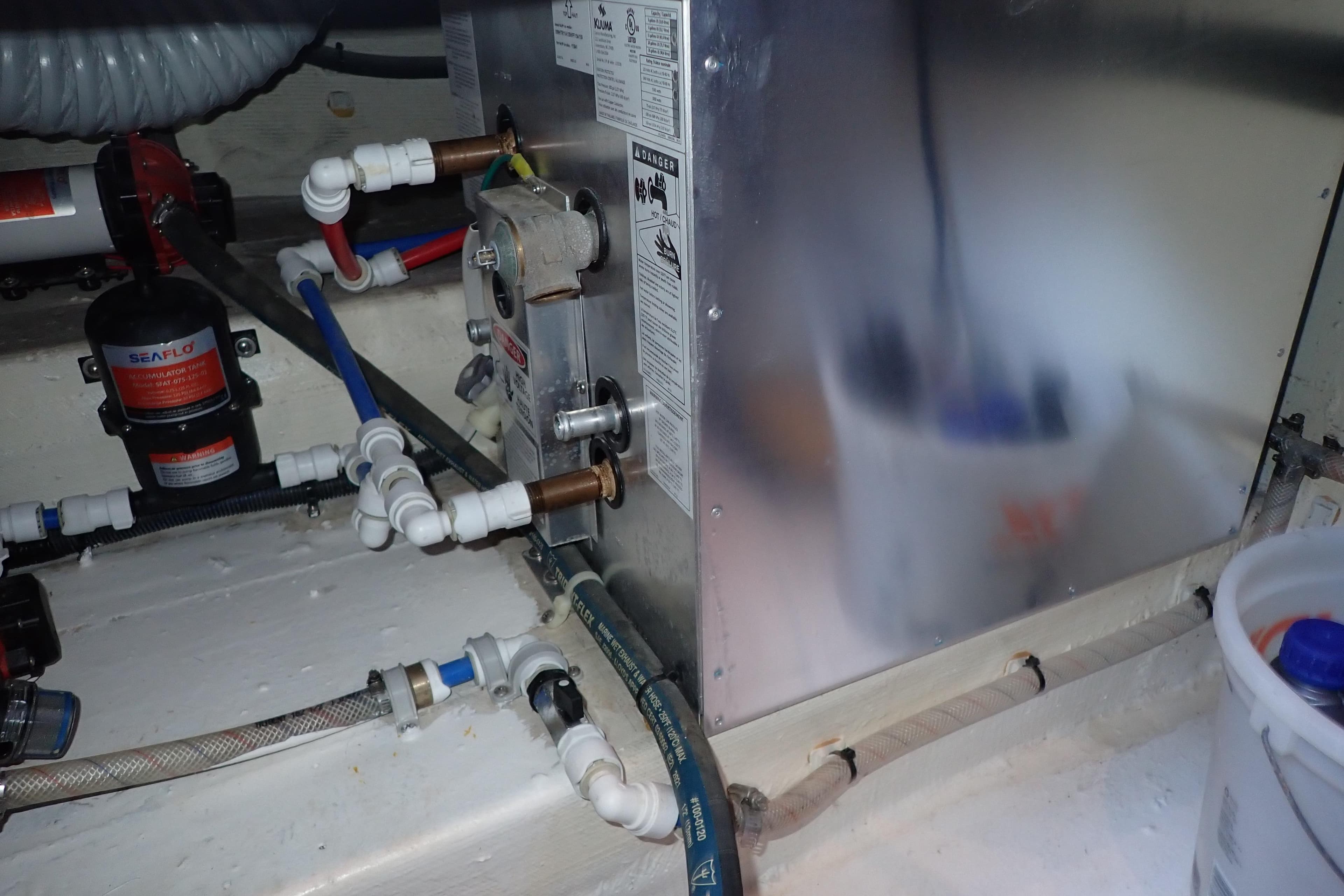 Engine room of 2023 True North 34 Outboard Express with plumbing and equipment.