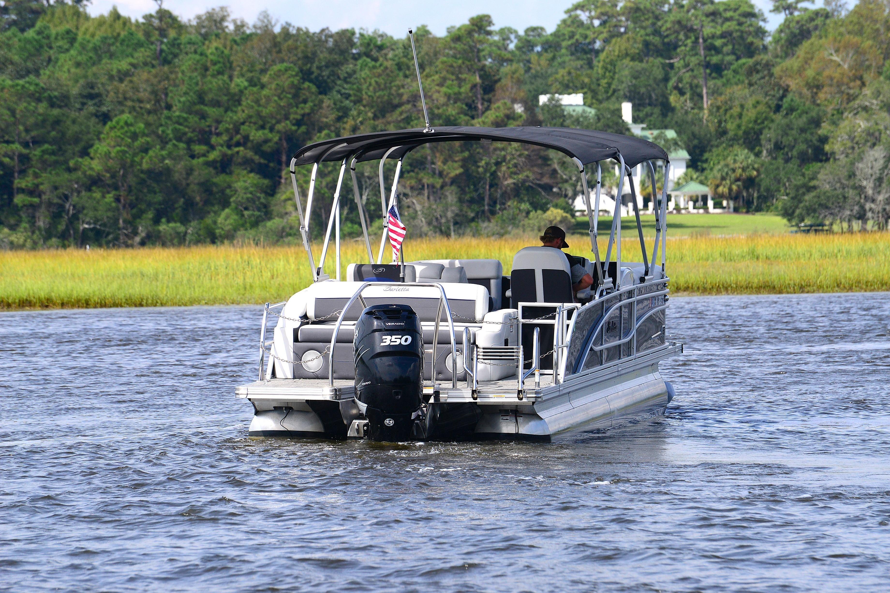 2022 Barletta Corsa 25U pontoon boat cruising on a scenic river.