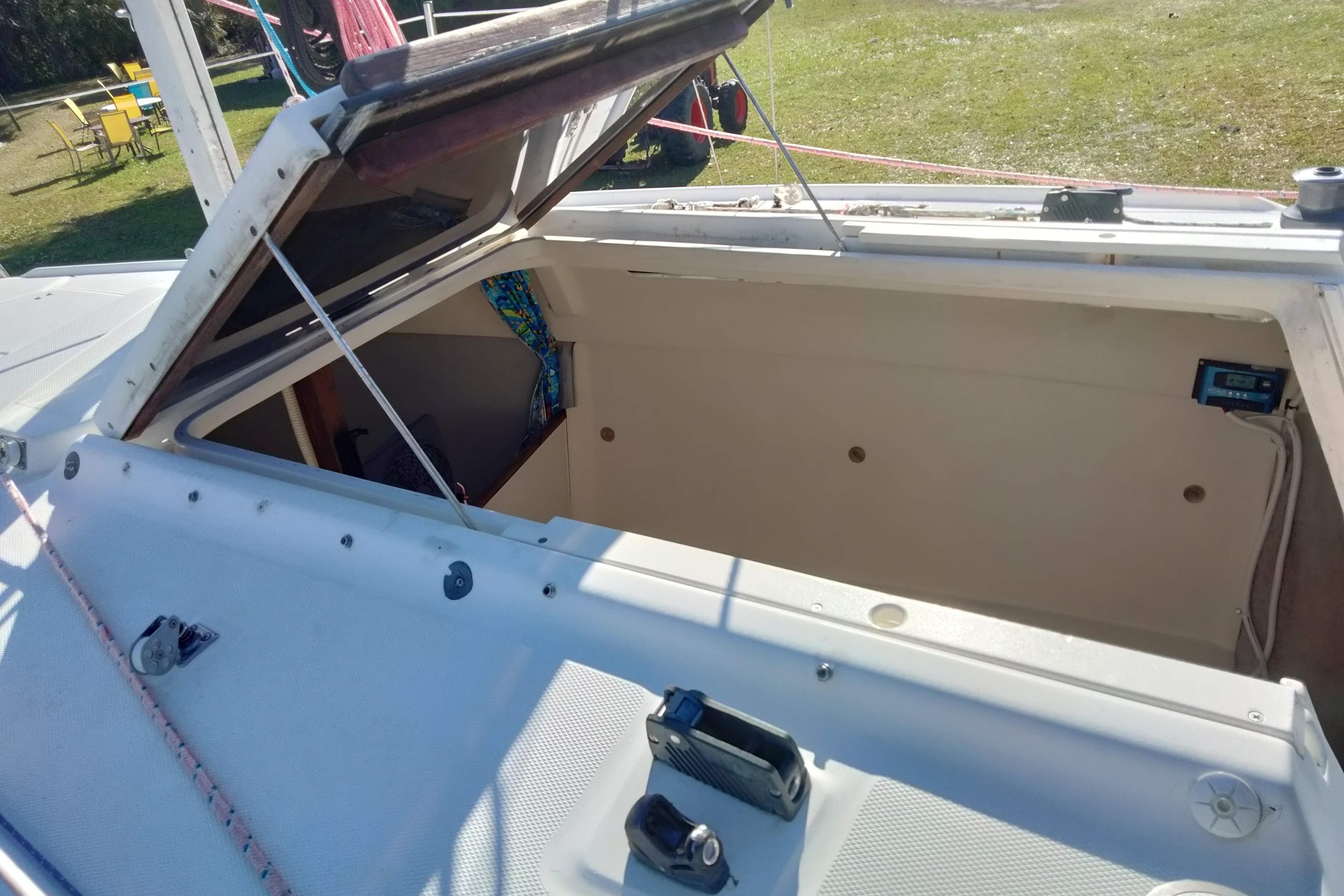 Open hatch on a 1998 Hunter 240 sailboat, showing interior storage space.