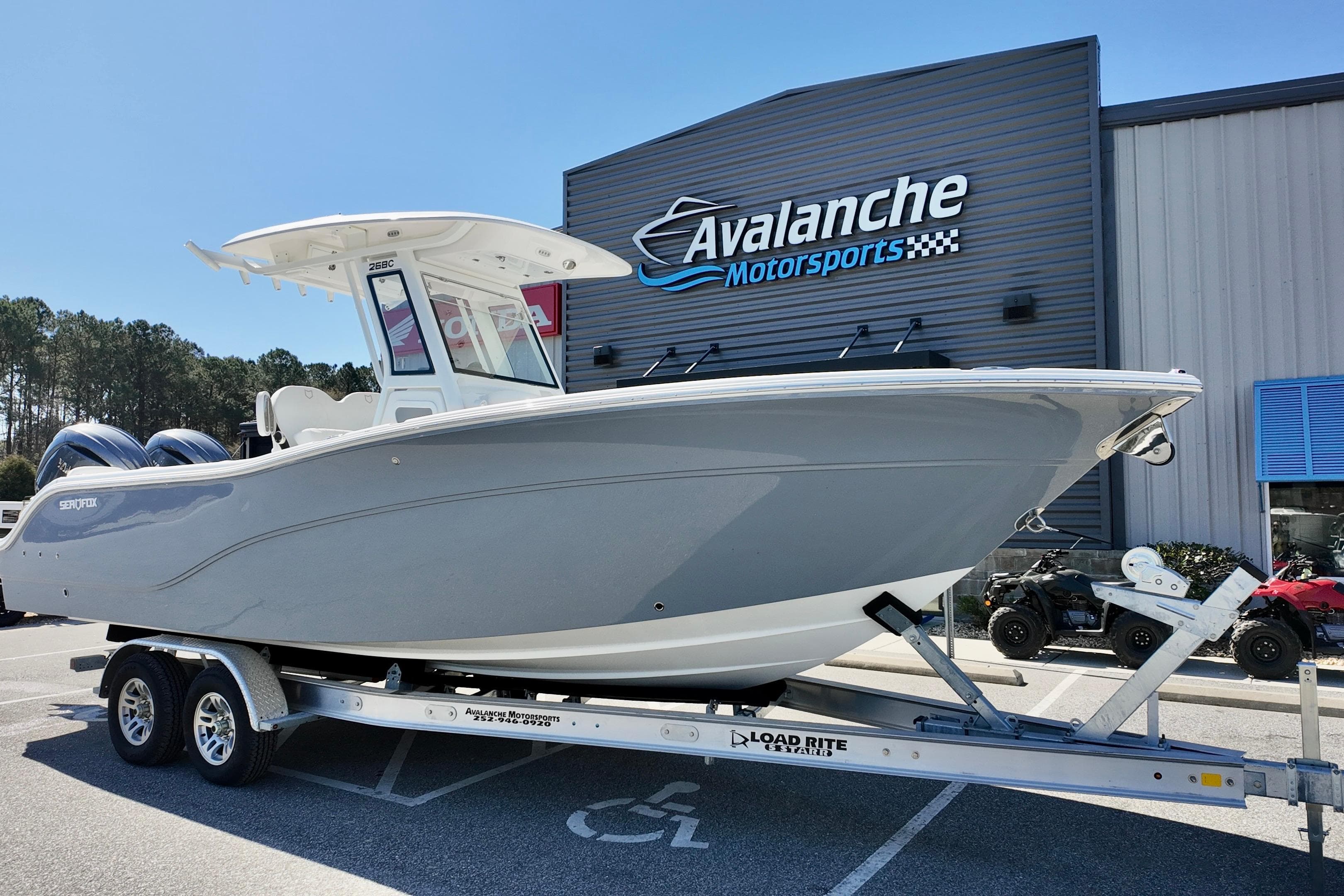 2026 Sea Fox 268 Commander boat on trailer at Avalanche Motorsports dealership.