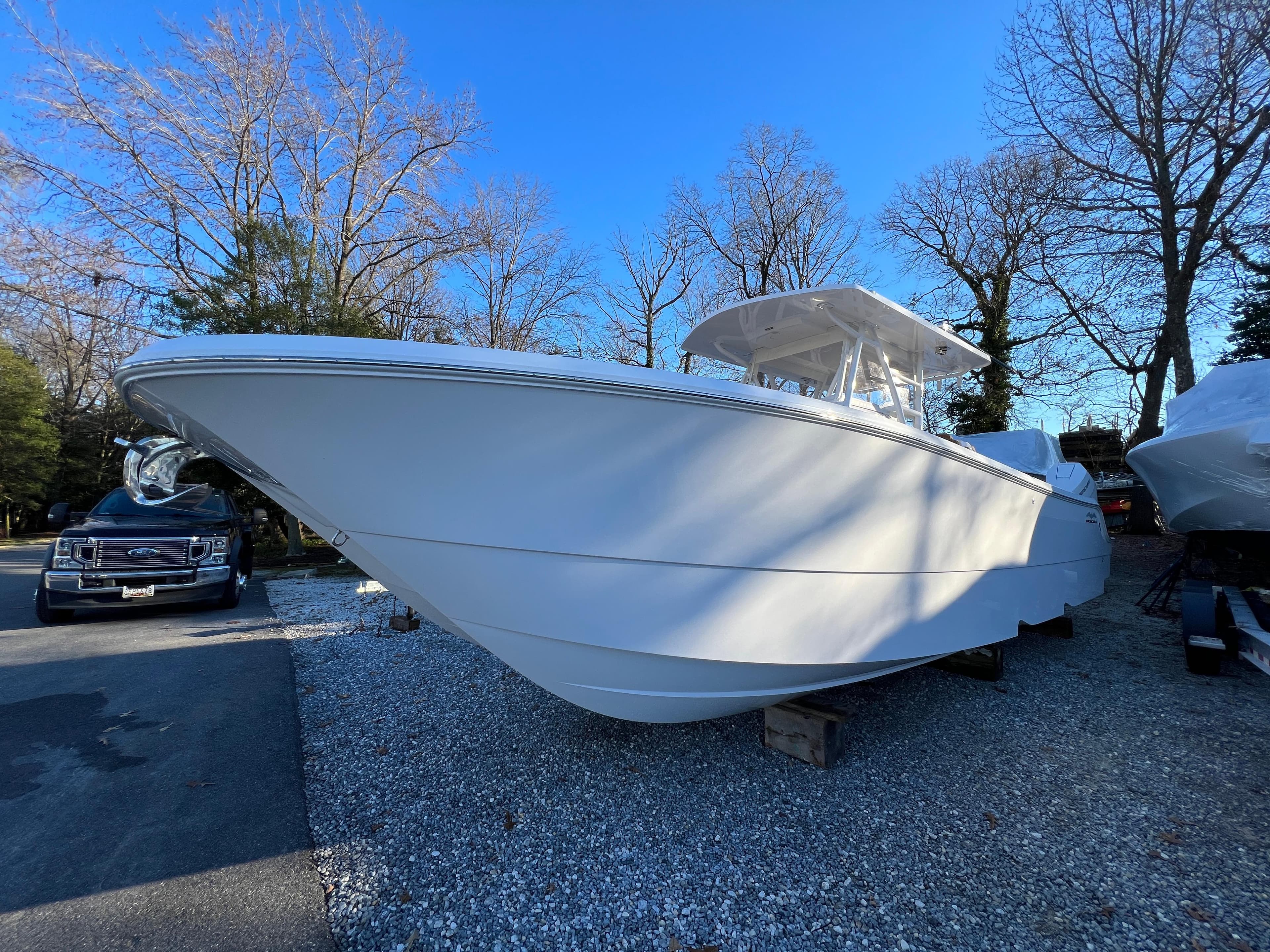 2025 Invincible 33 Catamaran boat on display in outdoor setting.