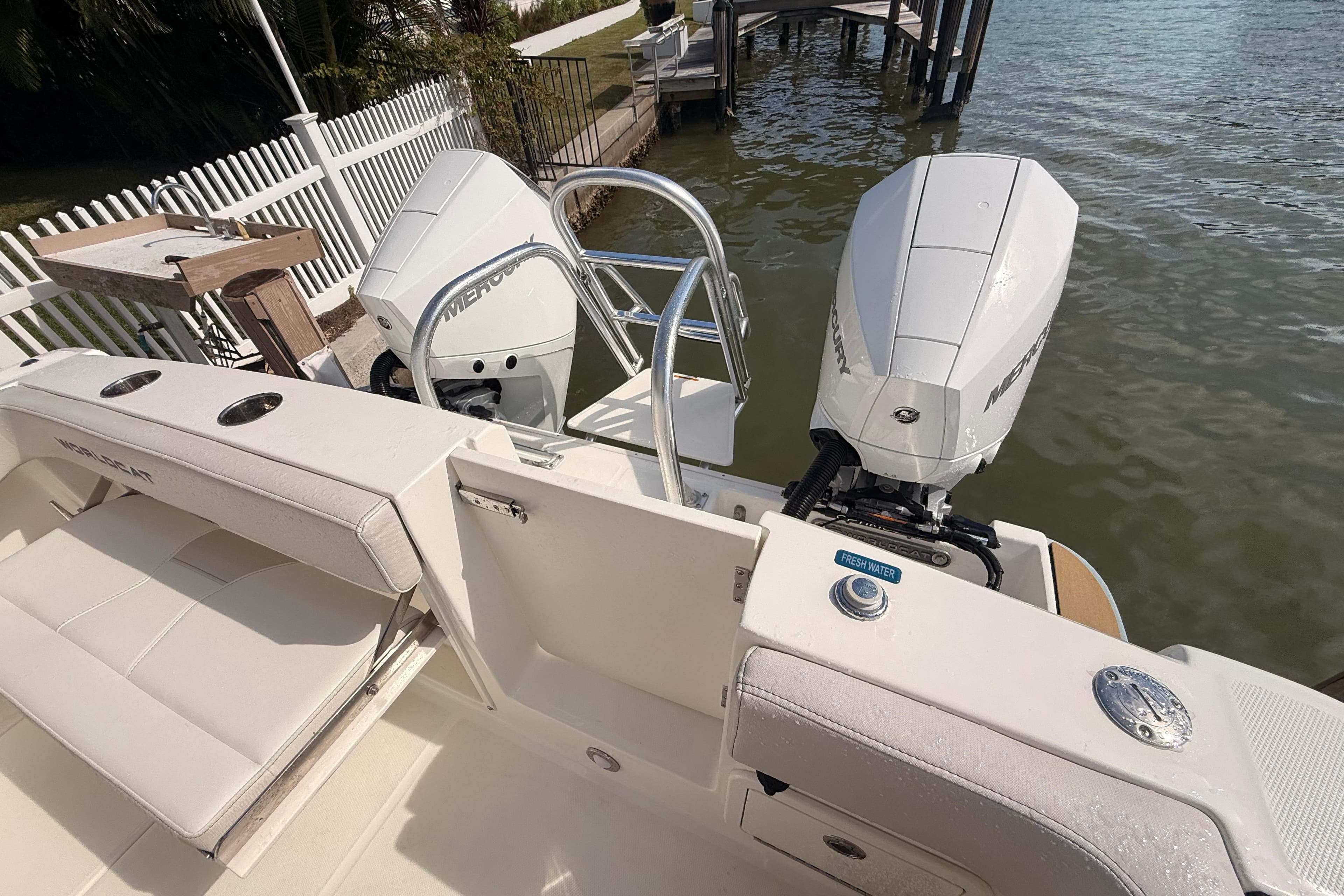 2025 World Cat 280 DC-X boat with dual Mercury outboard engines docked by water.